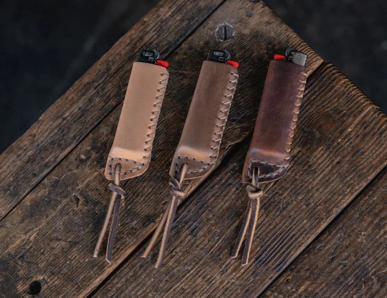 3 lighters in Craft and Lore Lighter Sleeves on a wooden table