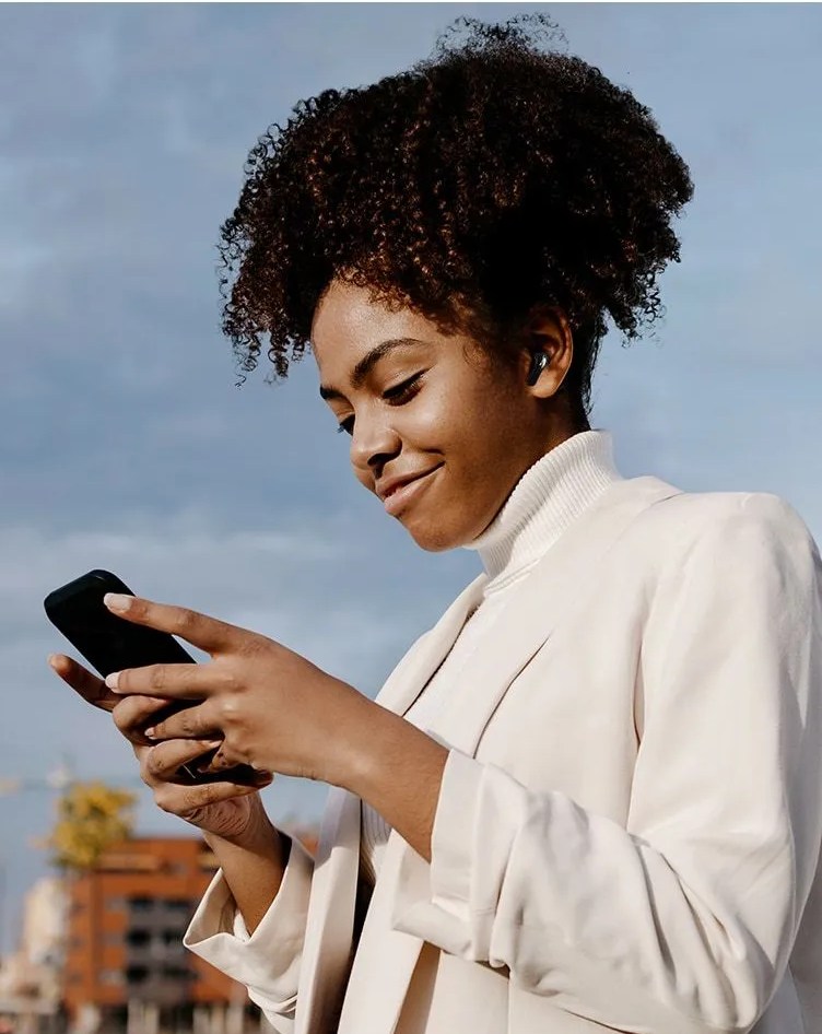 woman on phone wearing lg tone free ® t90q dolby atmos® with dolby head tracking™ true wireless bluetooth earbuds