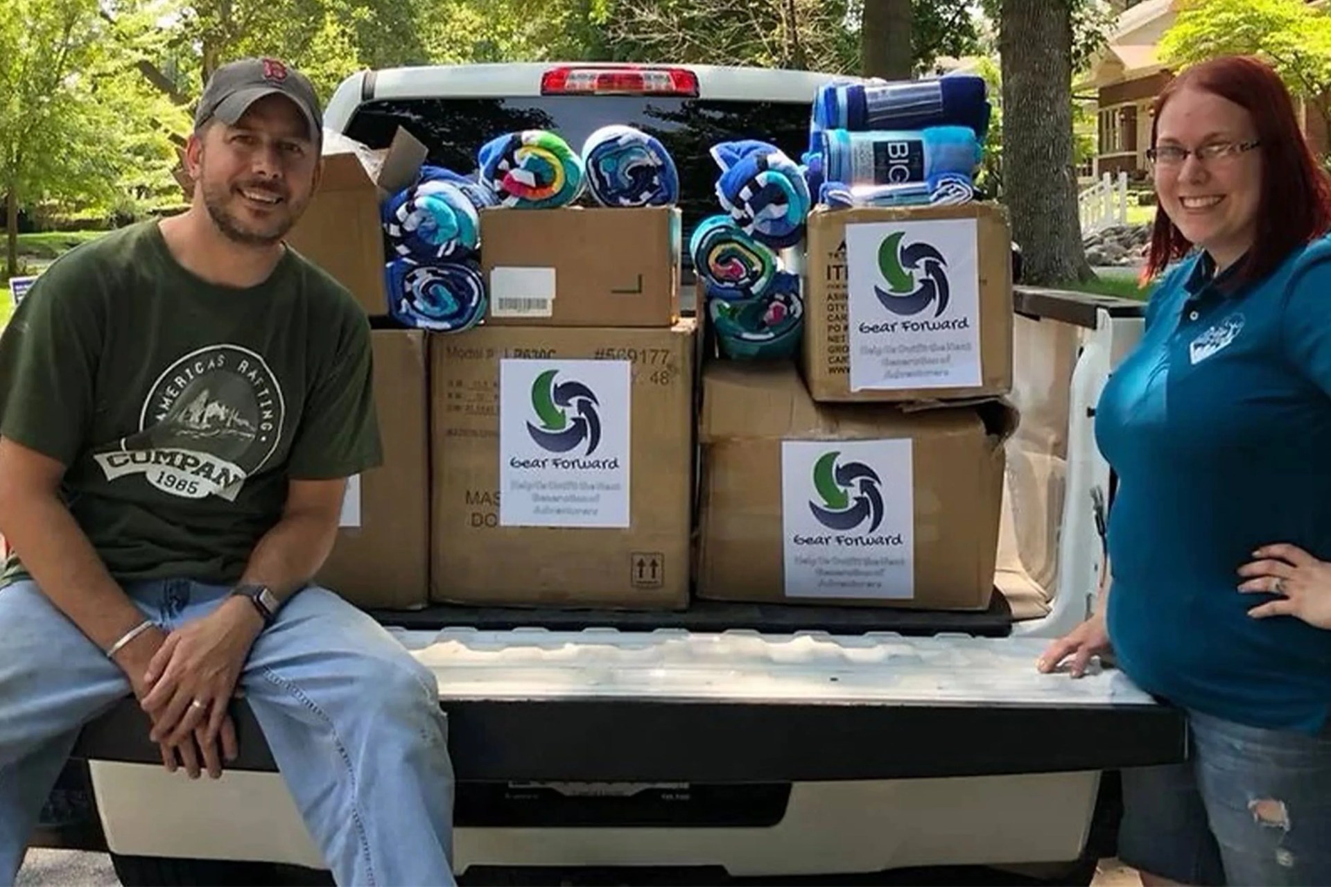 gear forward employees with a loaded up truck bed of donation boxes