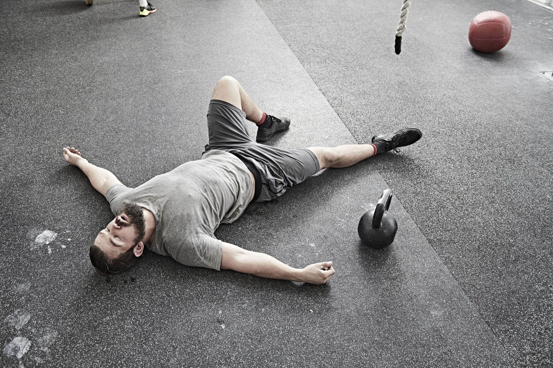 man taking break in cross training gym