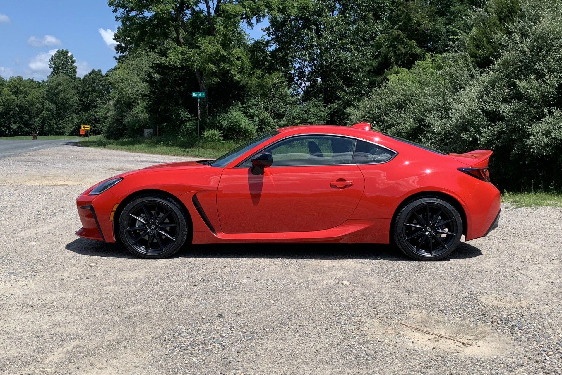 2022 toyota gr86 viewed form the side with woods in the background