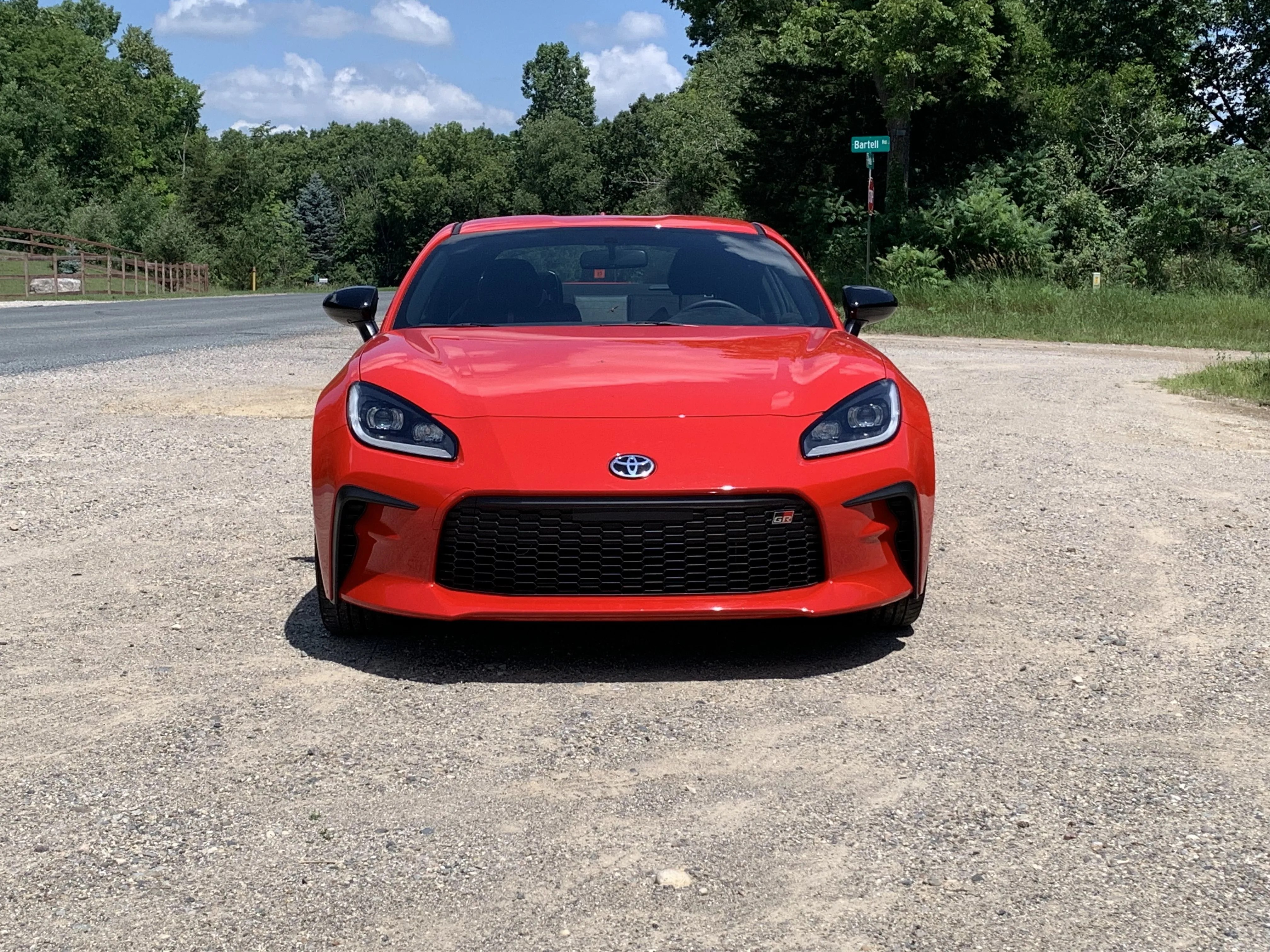 toyota gr86 viewed from the front parked alongside a rural street