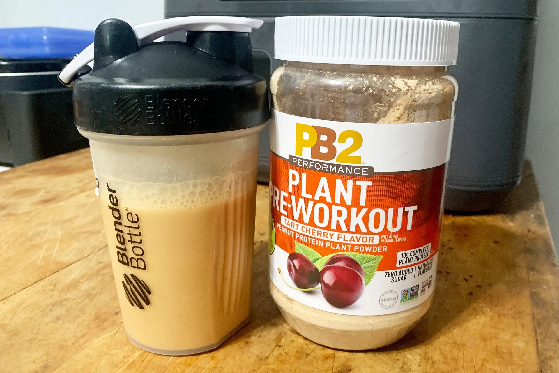 pb2 plant pre workout powder next to a blender bottle