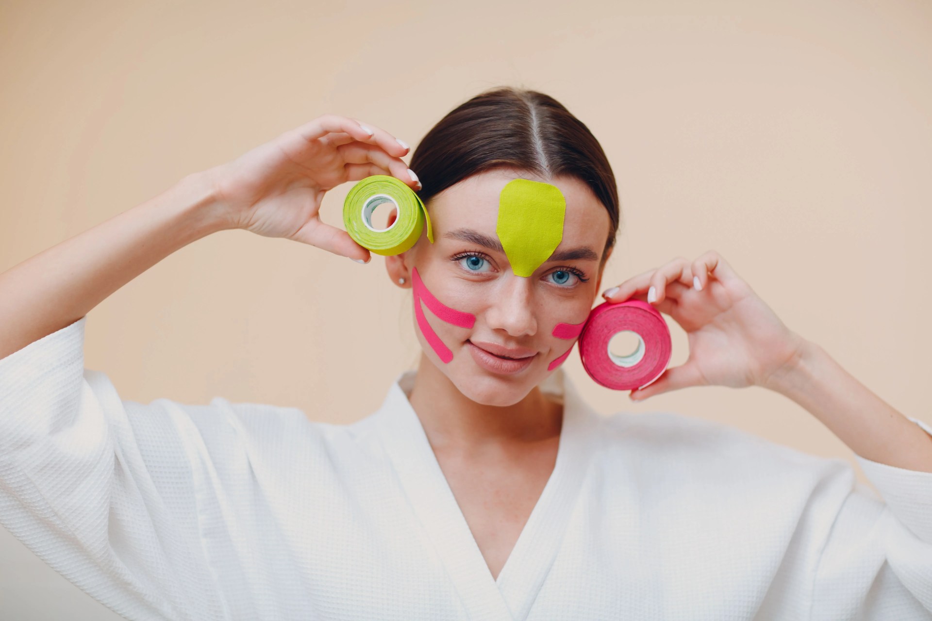 portrait of young woman holding prop while standing against wall