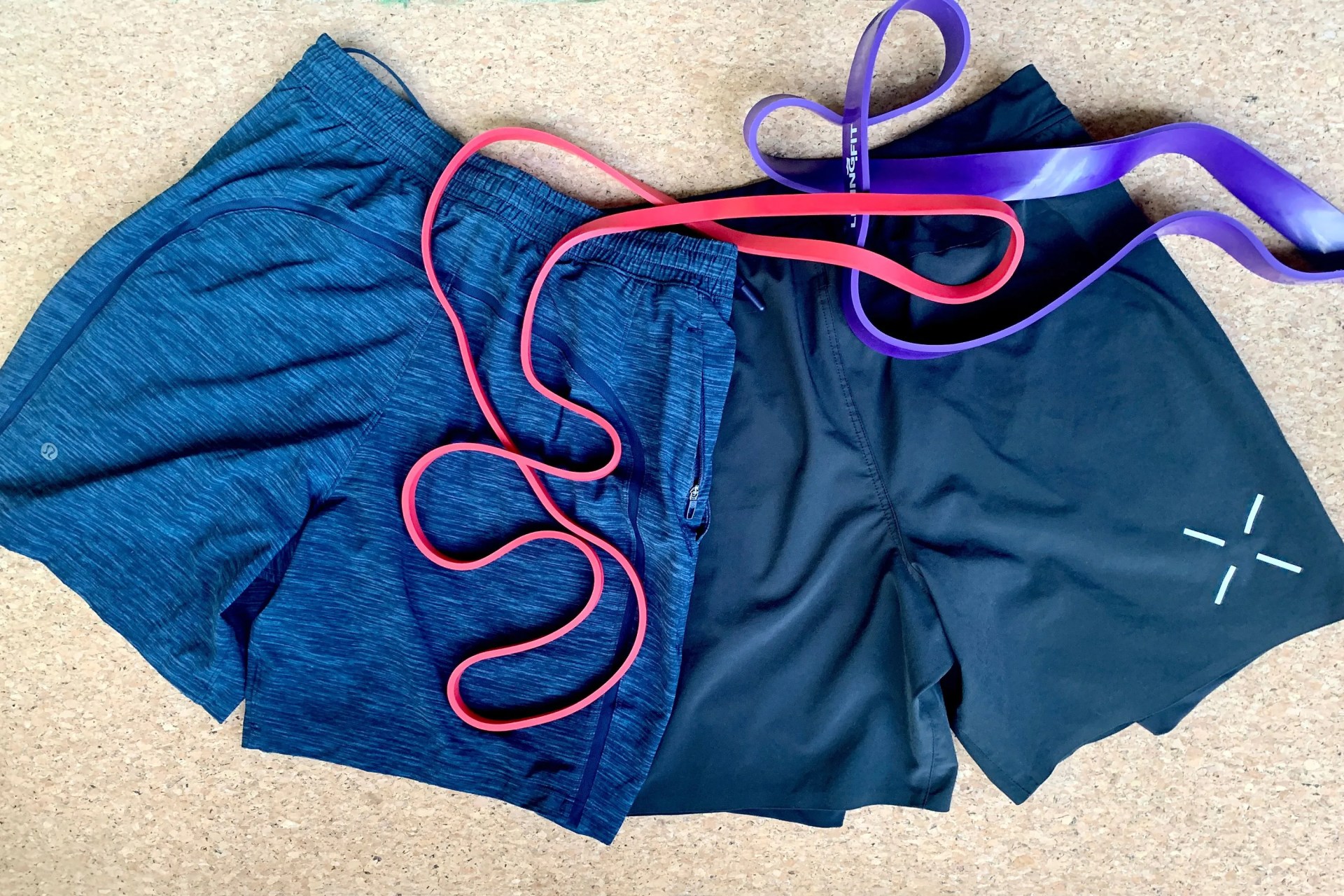 ten thousand and lululemon lemon shorts laying on an exercise mat with exercise bands