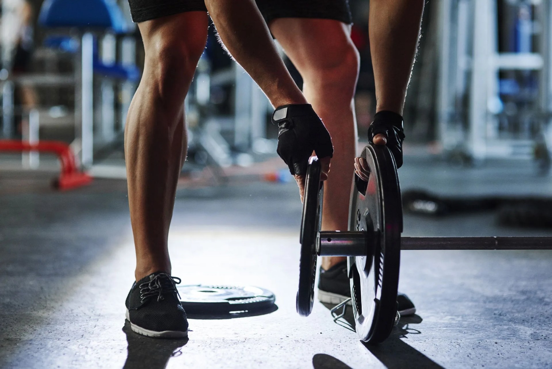 man preparing barbell in gym