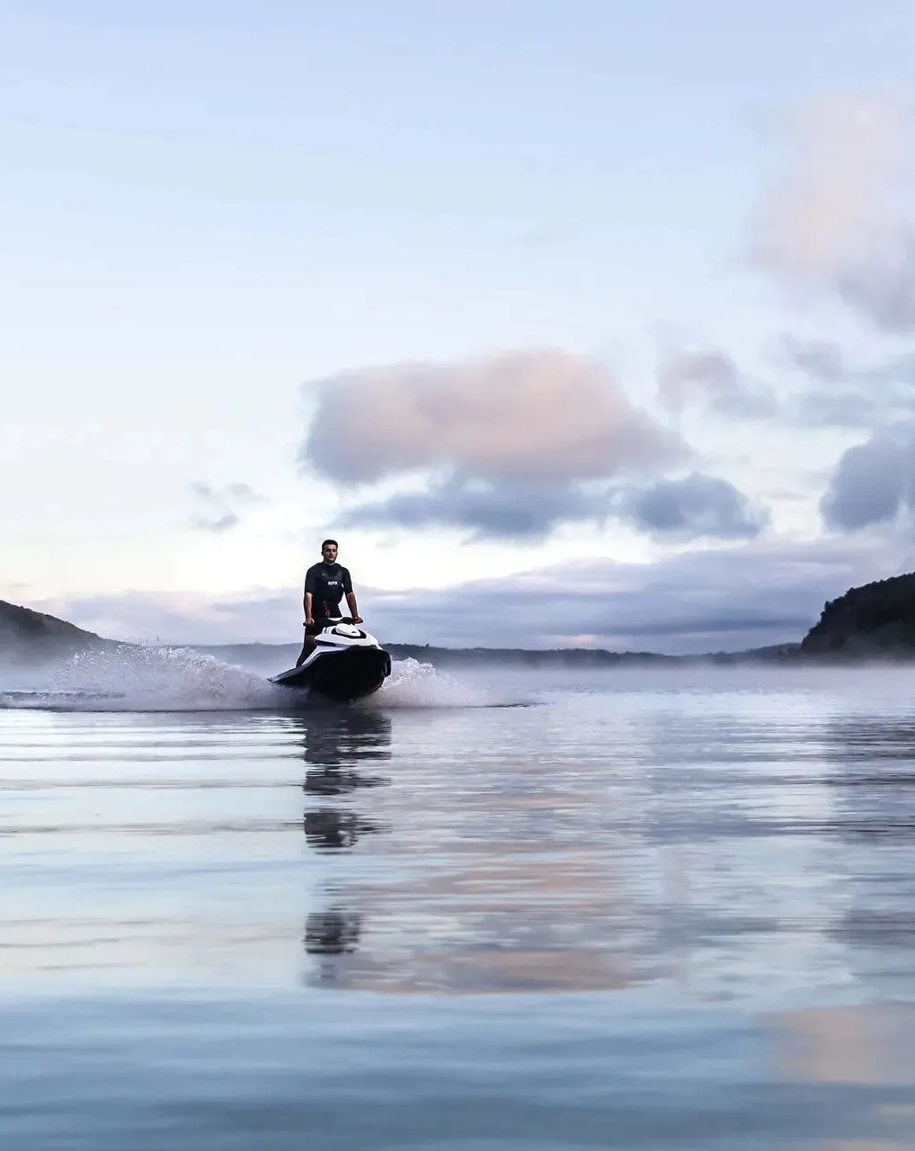man riding orca jetski on wave