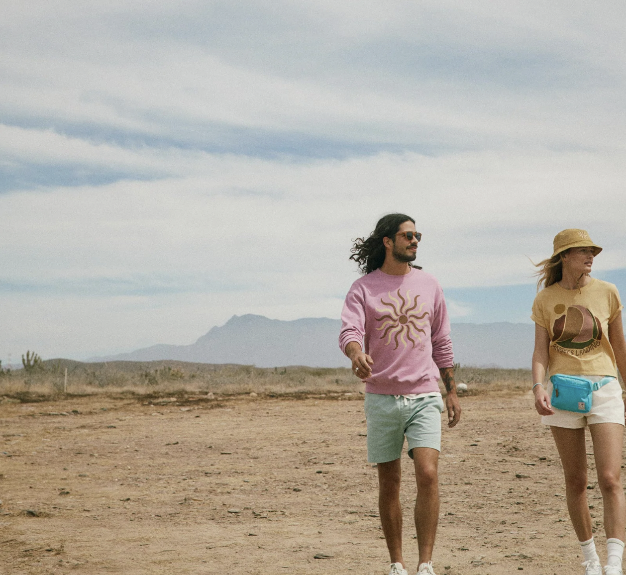 two people walking in desert