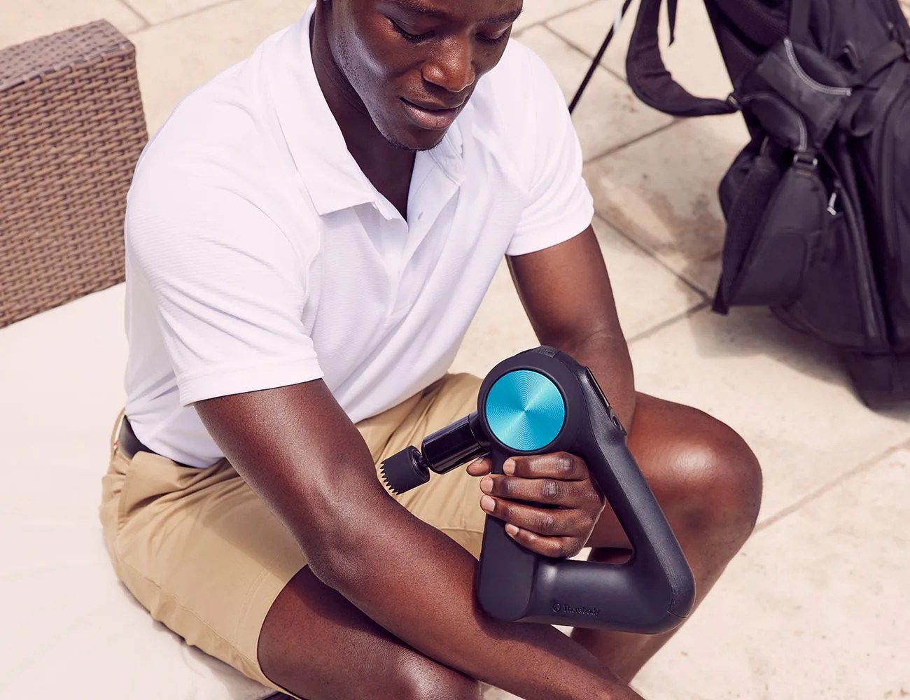 man using a therabody tool