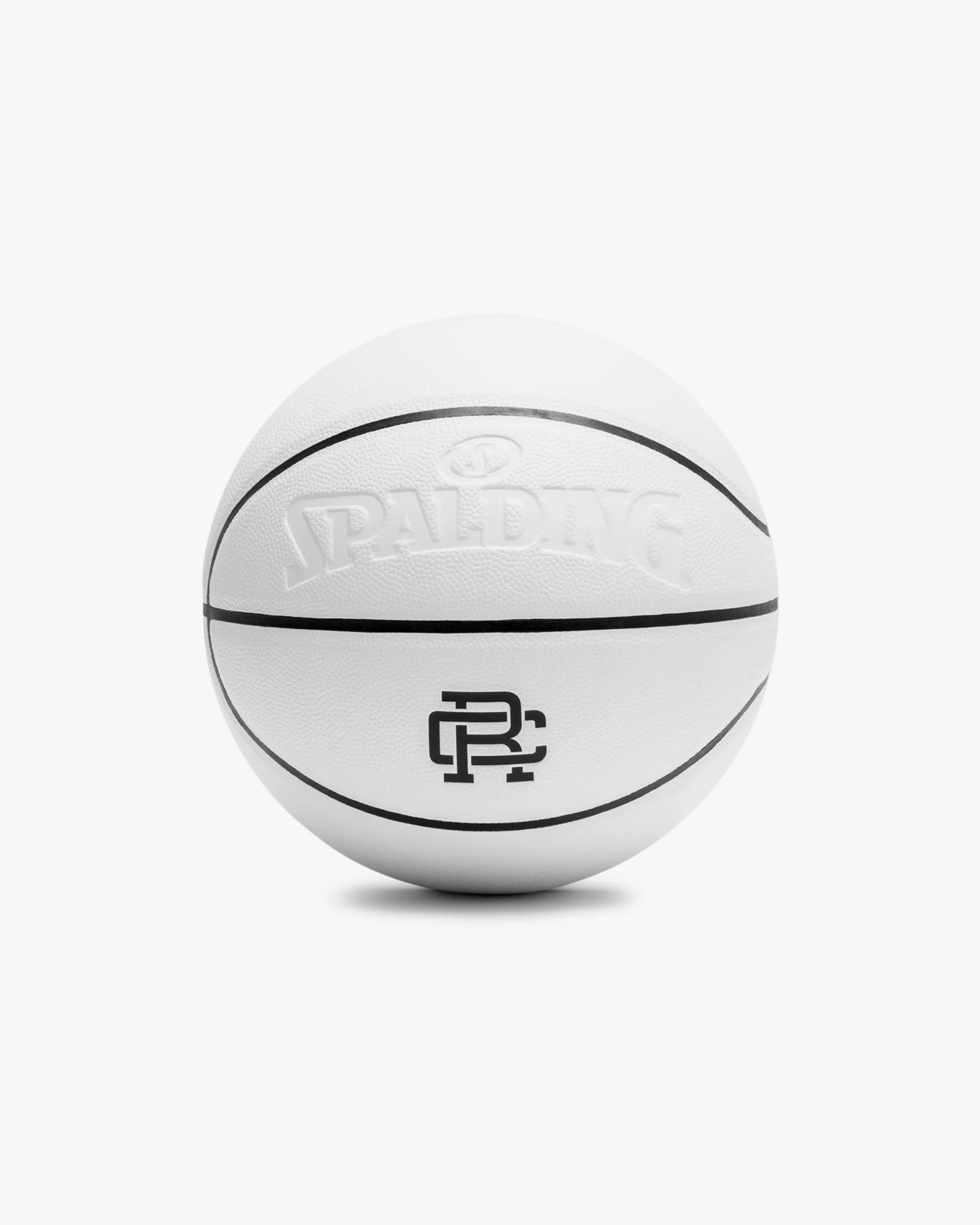 a white spalding x reigning champ basketball on a white background