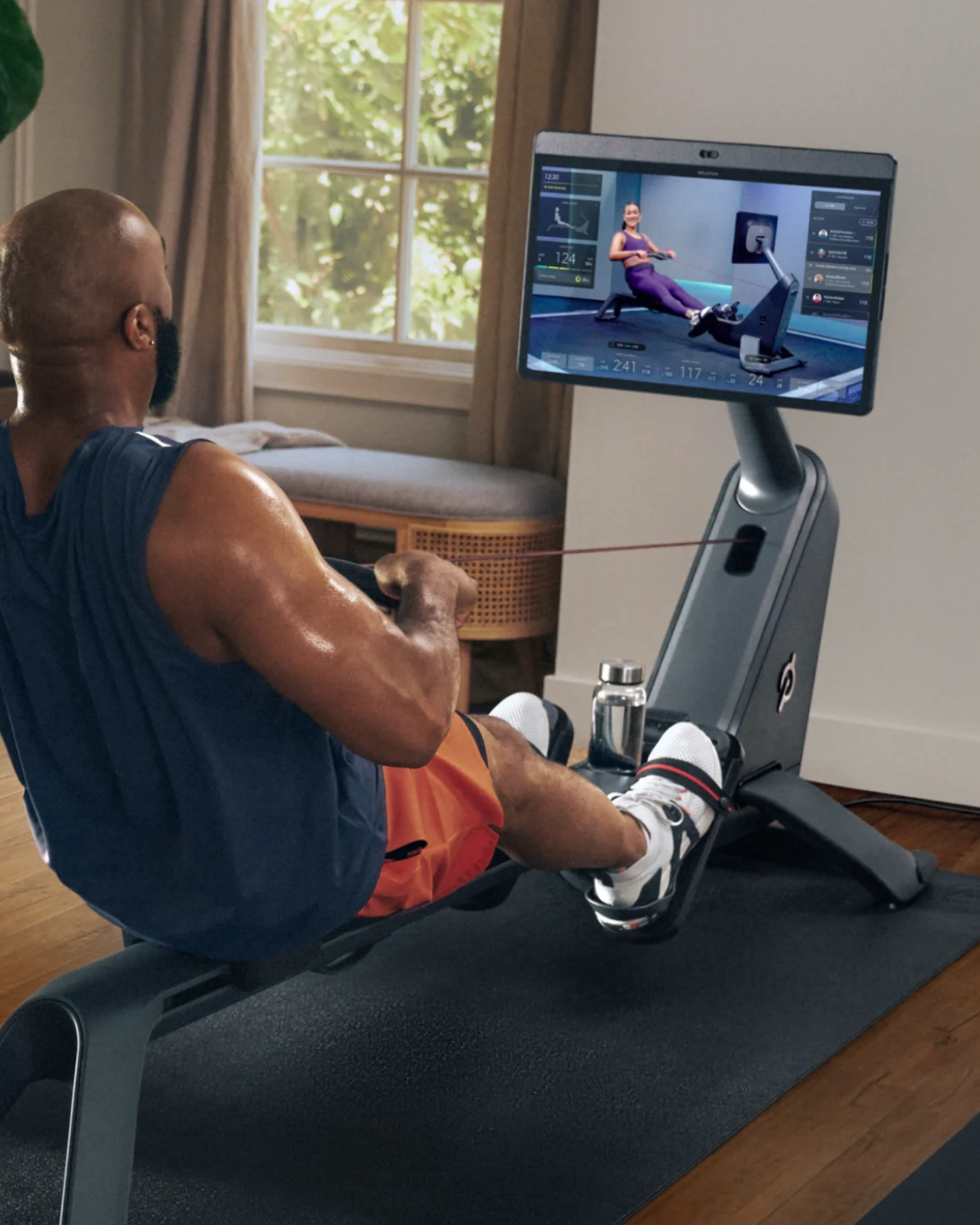 a man using the peloton row machine