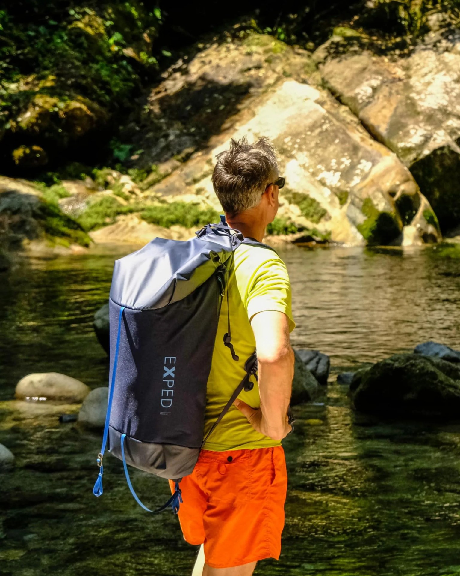 a man wearing the  exped radical 30 duffel backpack in navy