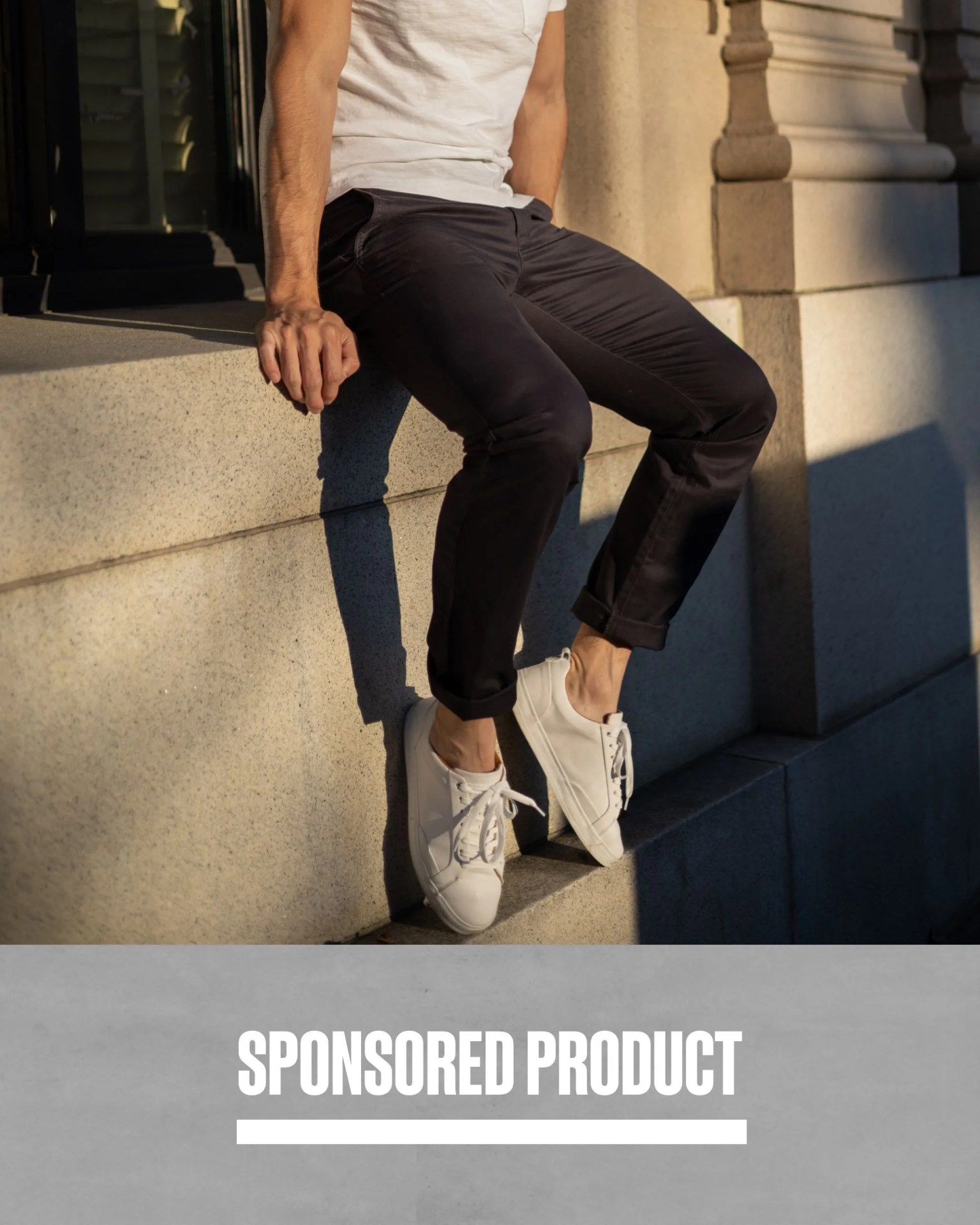 sponsored product man wearing perk feel good chinos in solid black while sitting down