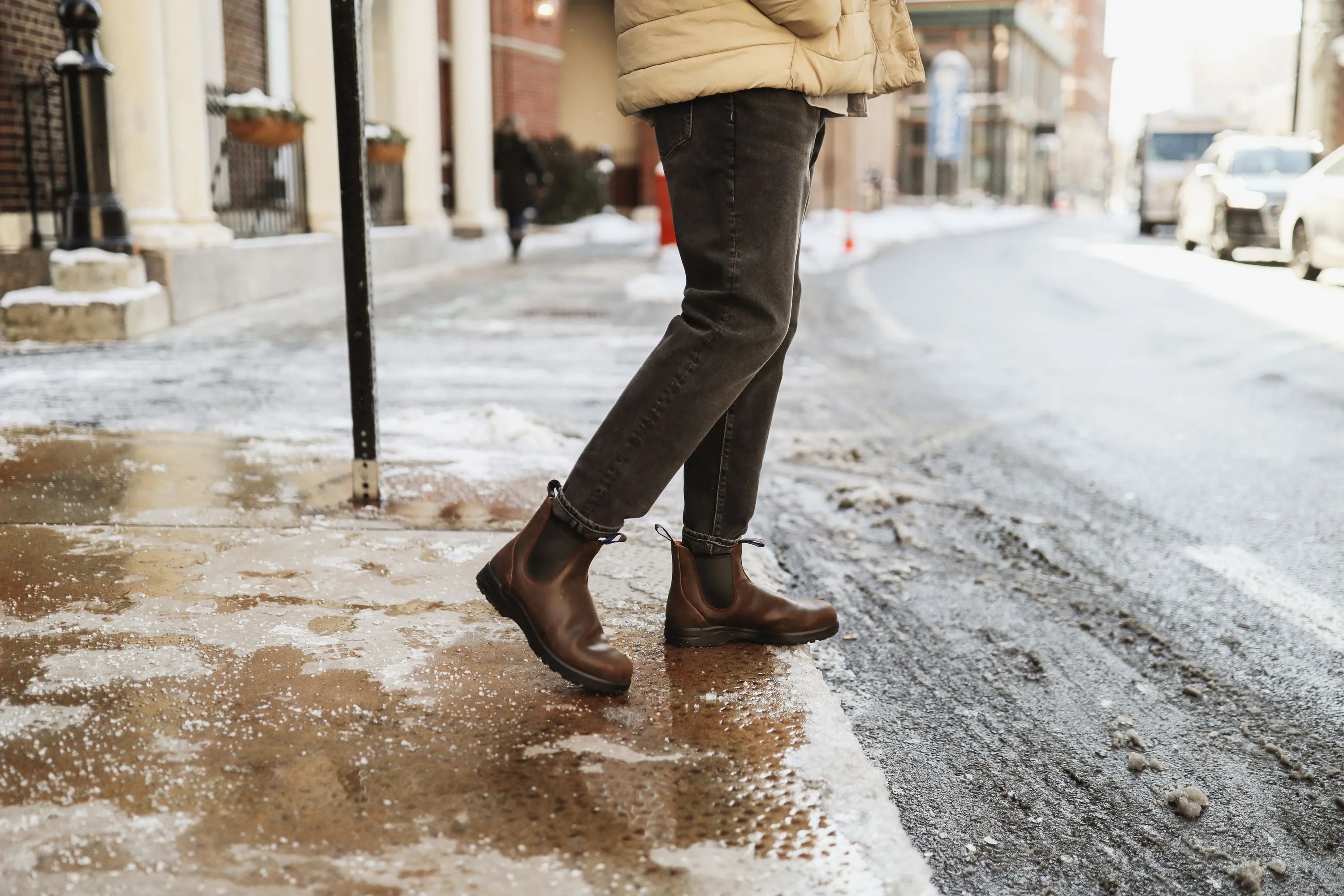 man crossing street wearing blundstone boots