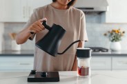 someone using a fellow stagg ekg pro edition kettle to make coffee