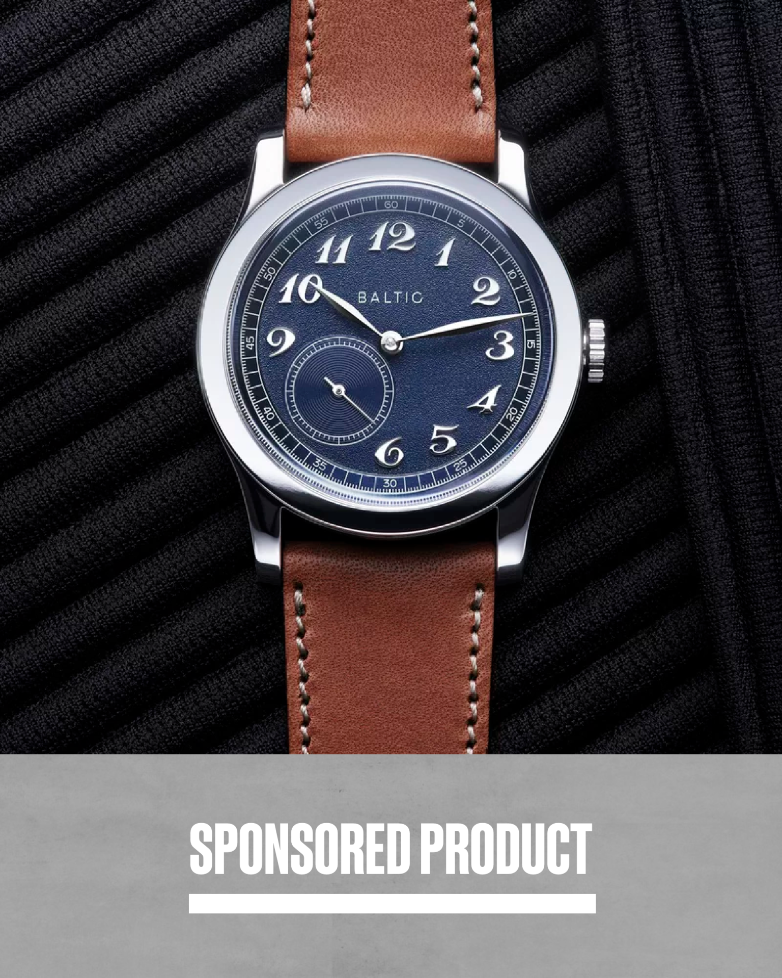a baltic watch with a blue dial and brown leather strap