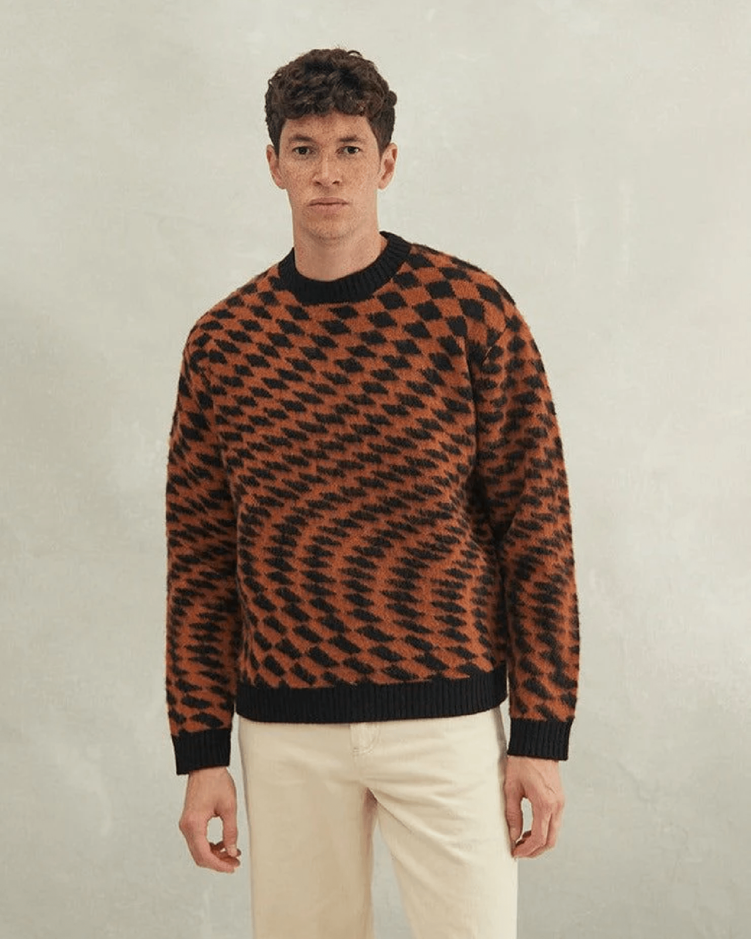 a percival sweater with orange and black checkered pattern