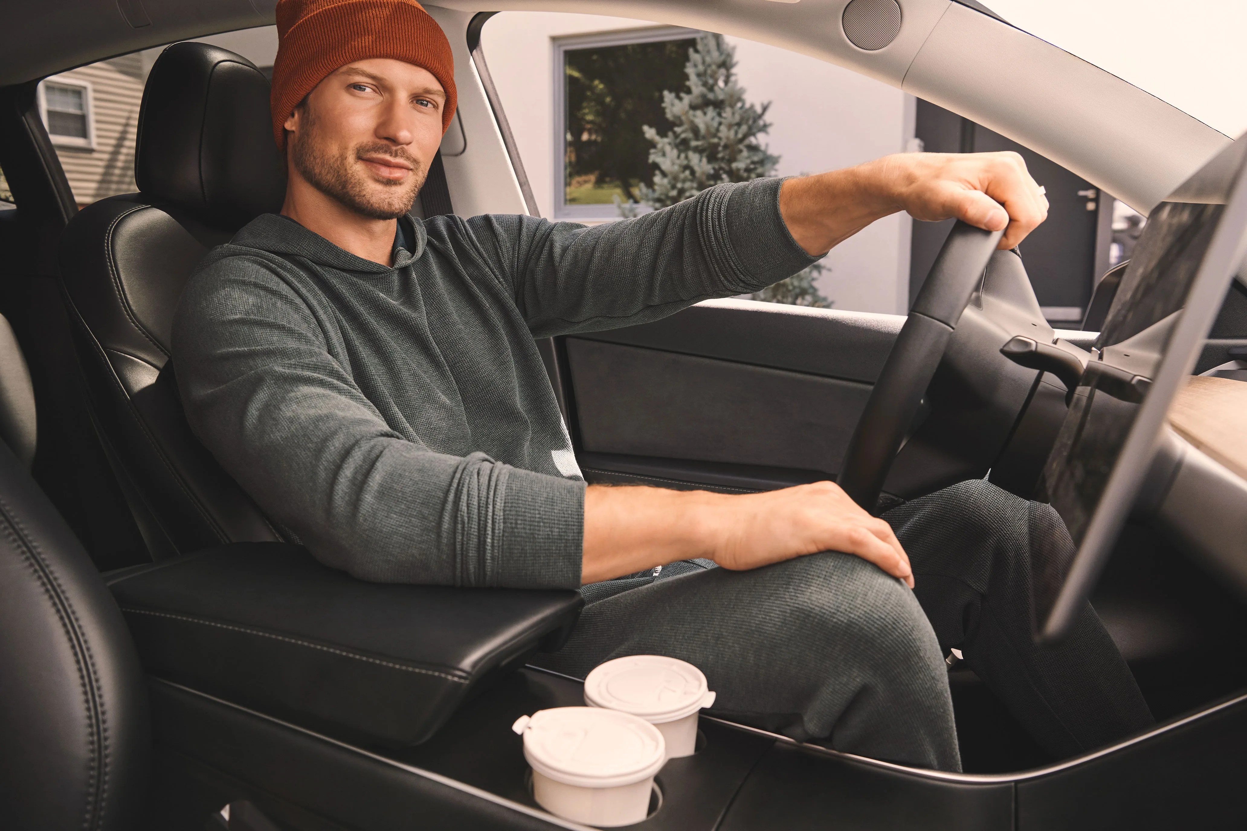 man sitting in car with his hand on steering wheel wearing tommy john zen waffle lounge set