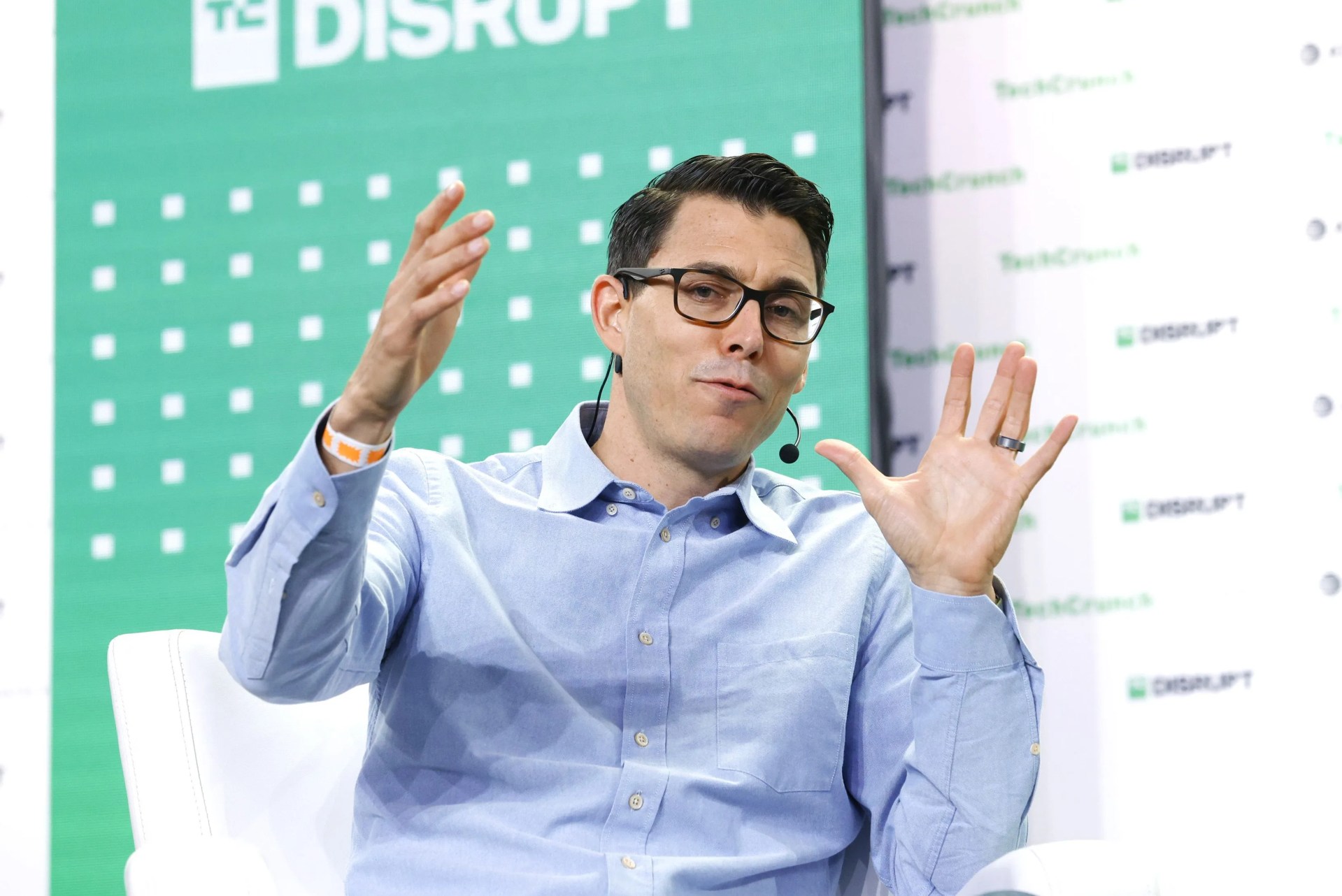 rj scaringe speaking at tech disrupt and gesturing