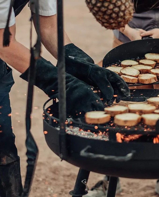man grilling using barebones accessories