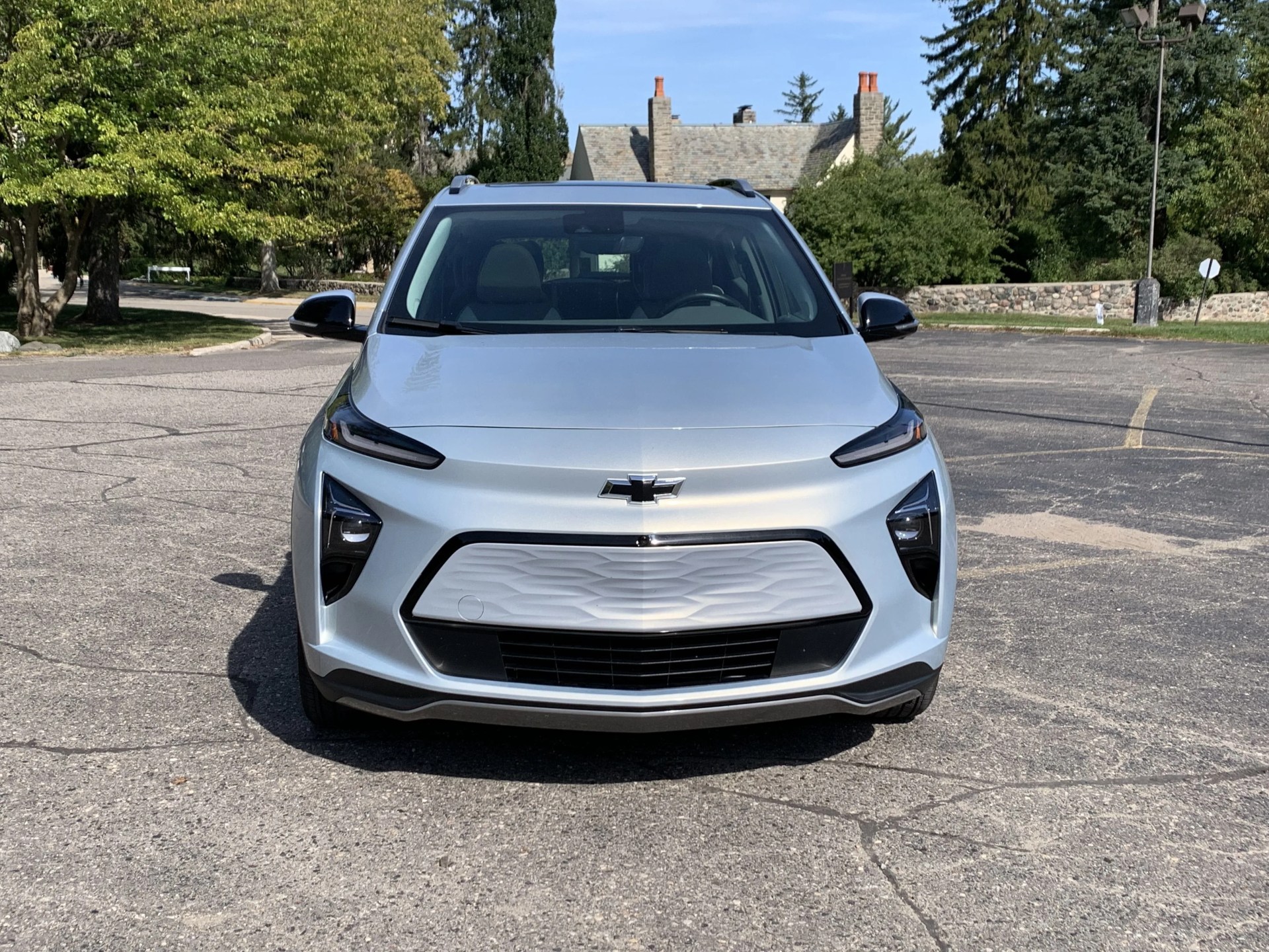 silver chevy bolt euv in parking lot in front of a church