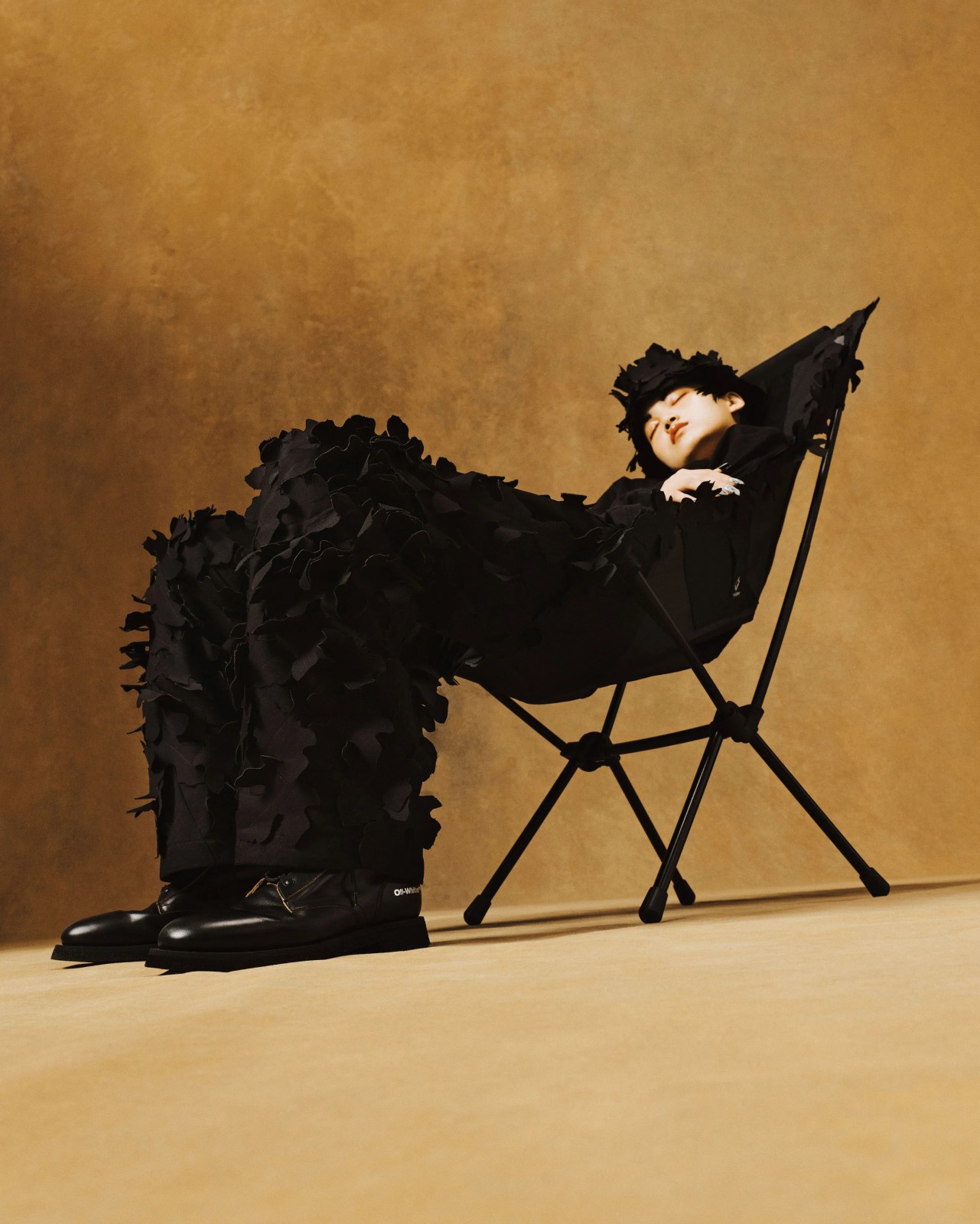 man wearing helinox off white equipment chair