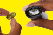 hands putting weed flower into a pax vape pen