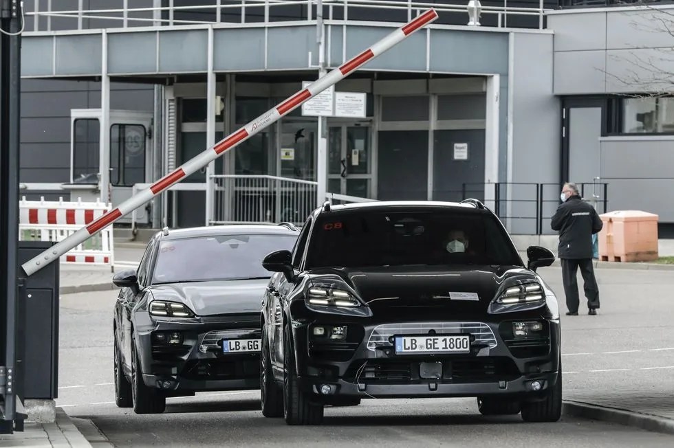 porsche electric macan prototypes leaving a gated parking lot