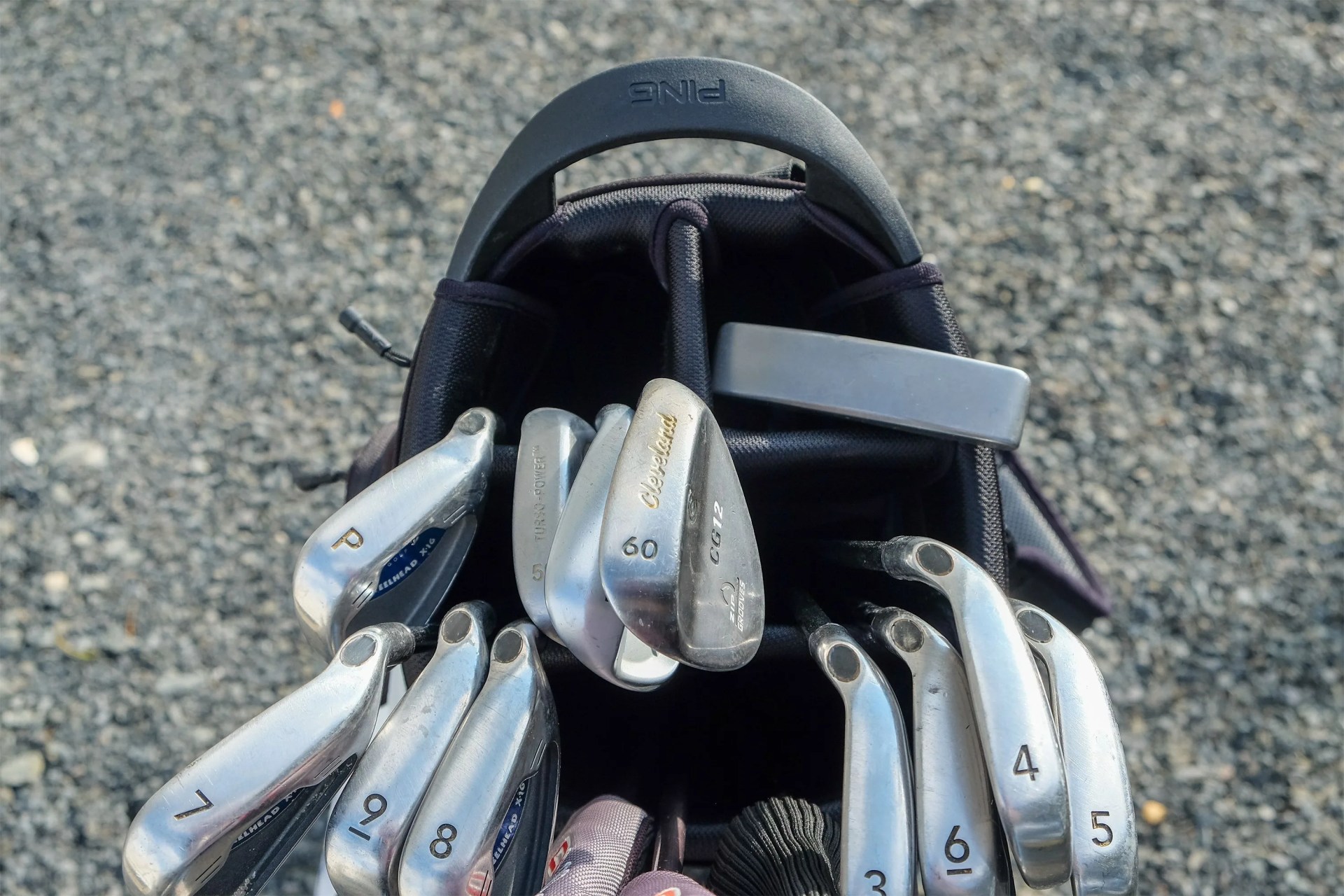 golf clubs in a ping hoofer stand golf bag