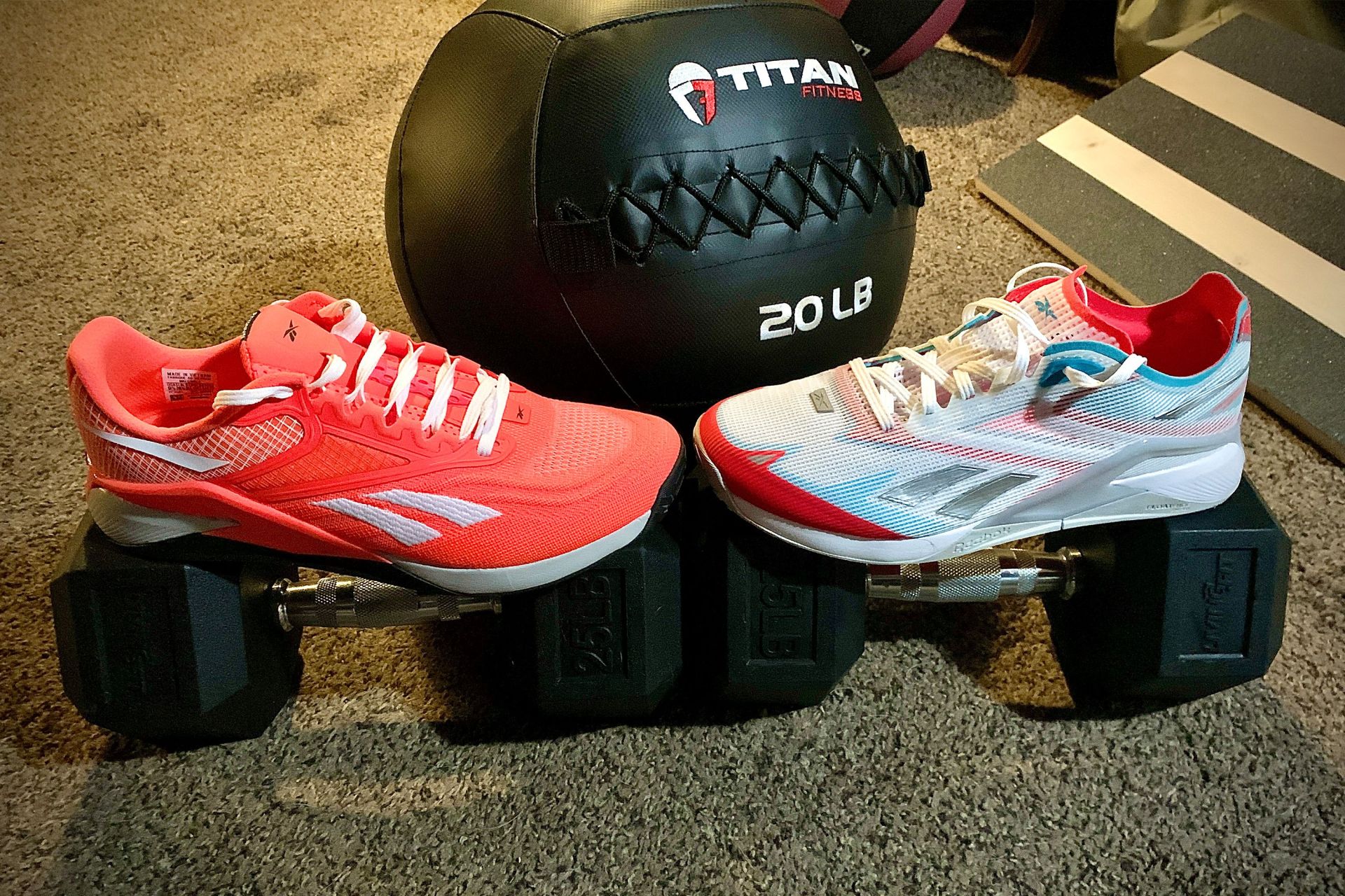 reebok nano x2 froning shoes on weights next to a weight ball