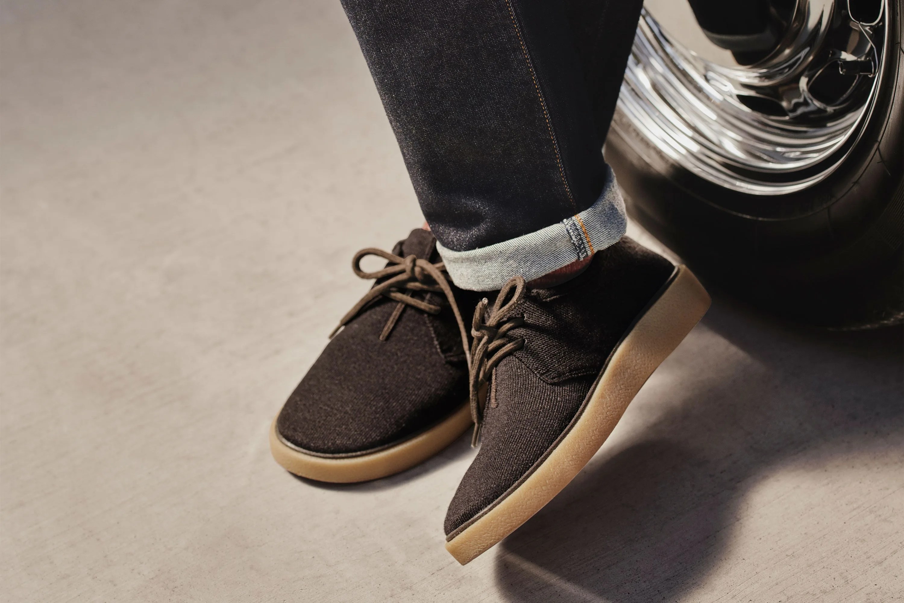 rothy shoes worn on man leaning against tire
