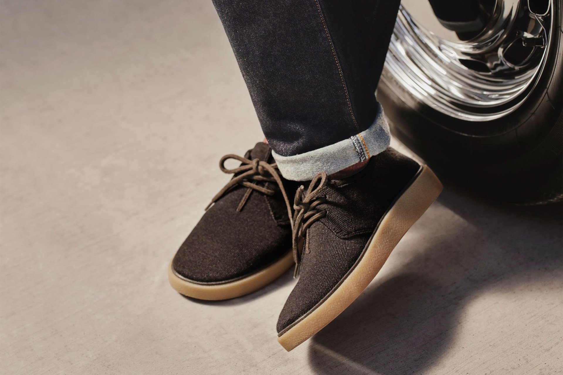 rothy shoes worn on man leaning against tire