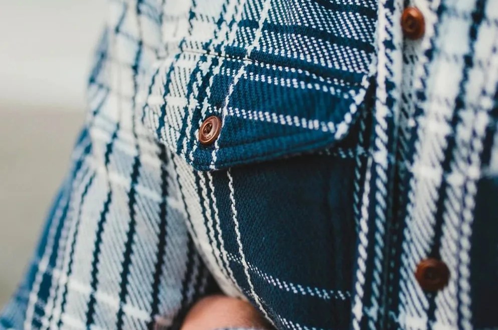 close up of an outerknown flannel shirt pocket