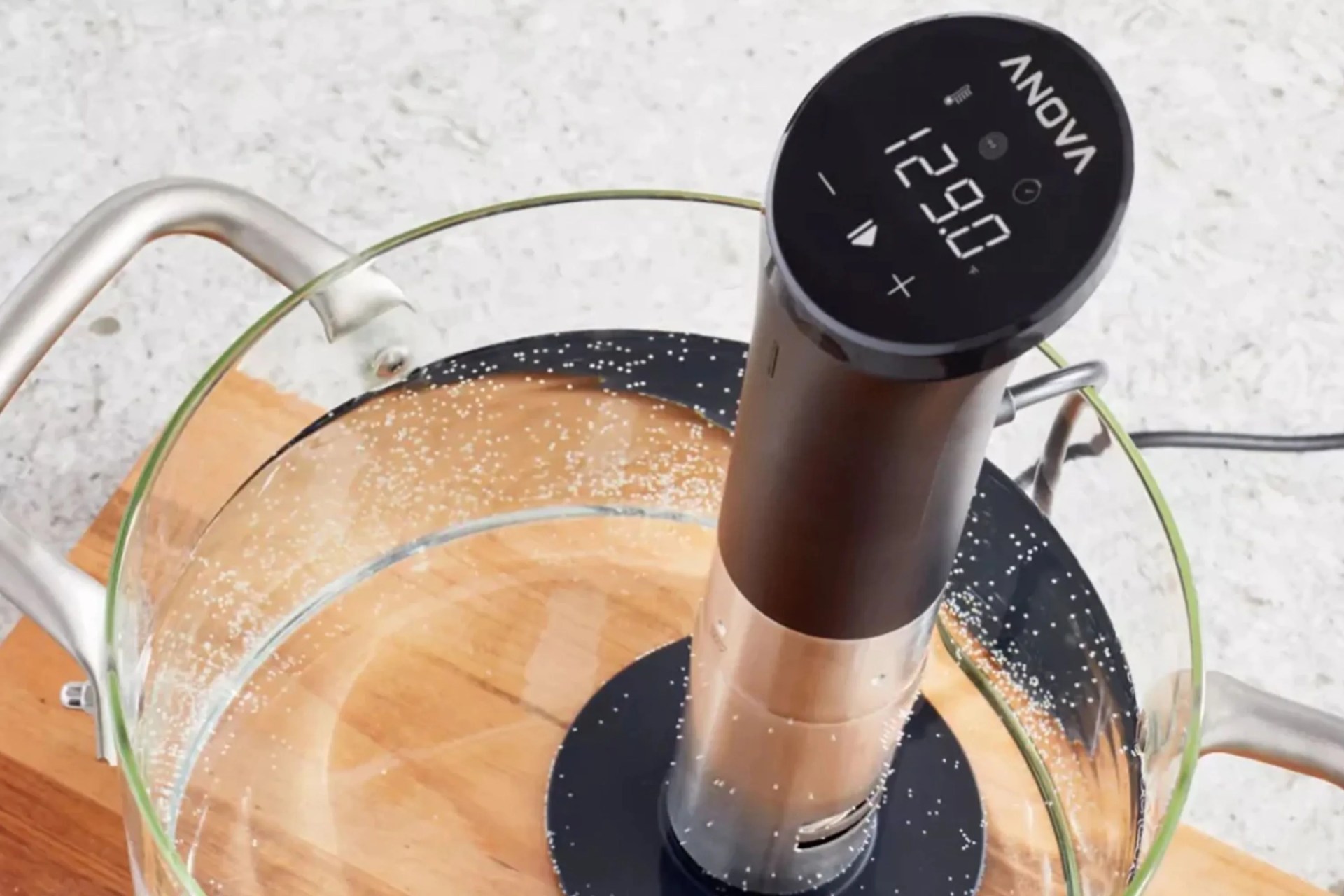 sou vide machine in a pot of water on a counter