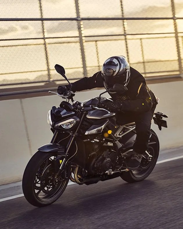 man riding triumph motorcycle street triple 765 r