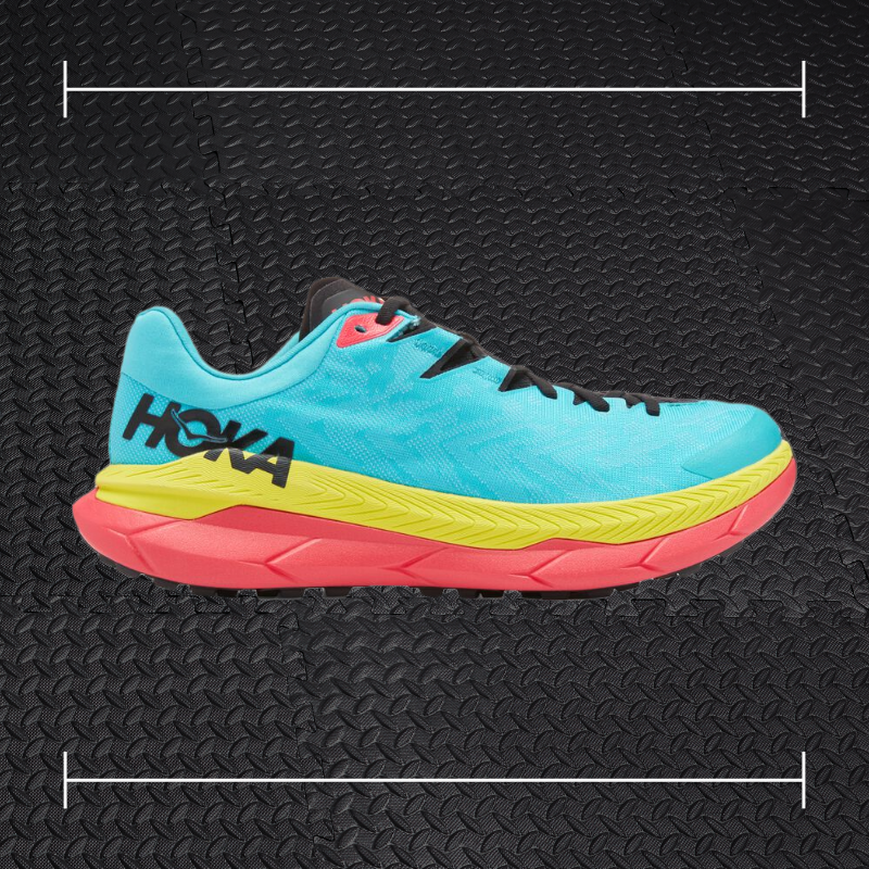 a blue yellow and pink hoka fitness shoe laid over top a photo of black rubber gym flooring