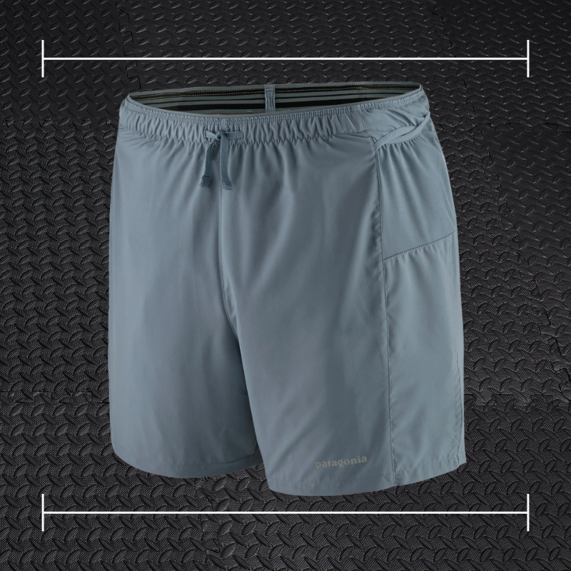 grey patagonia shorts laid on top a photo of black rubber gym flooring