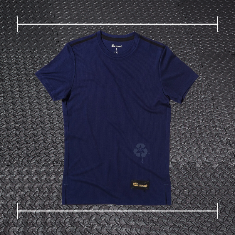 a blue purple short sleeve shirt laid on top a photo of black rubber gym flooring