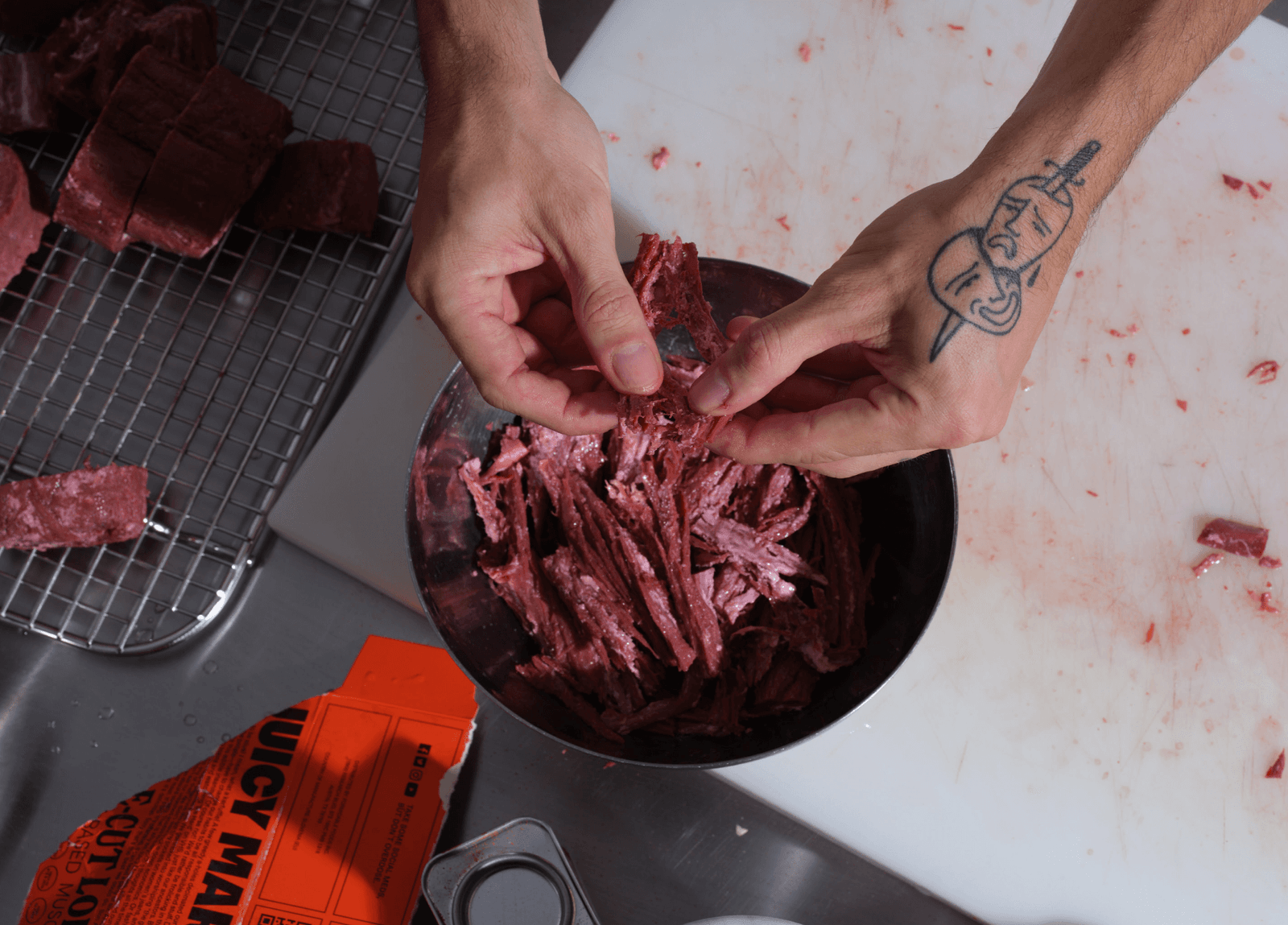 someone shredding juicy marbles meat into a bowl