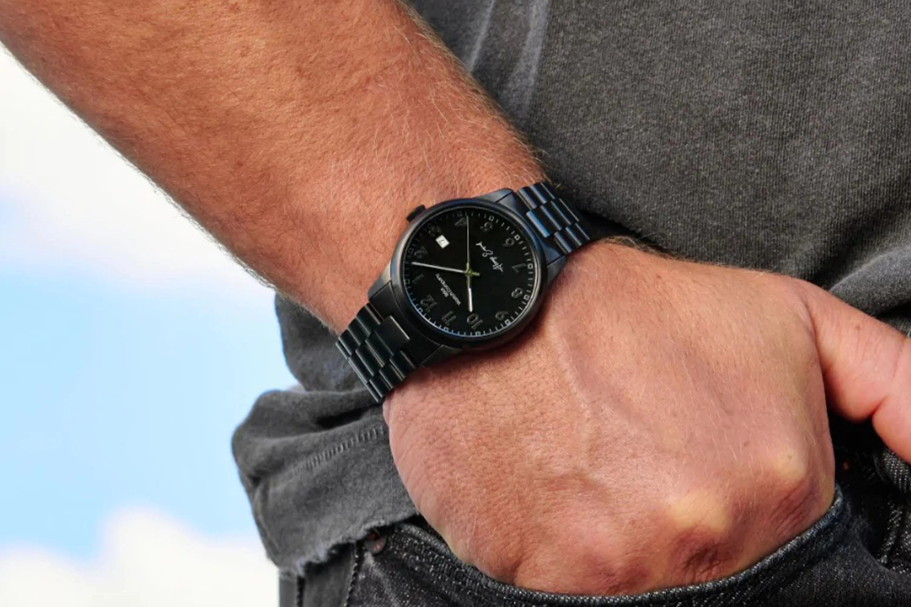 black brick watch on a mans wrist
