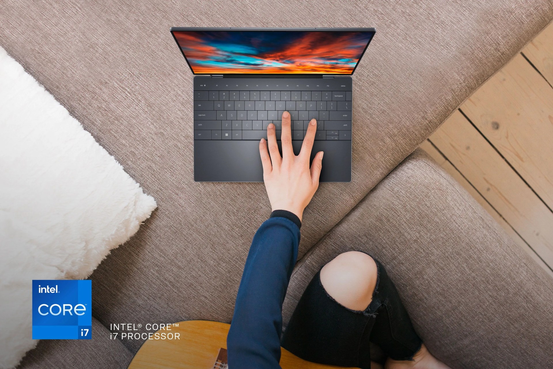 person holding guitar with one hand typing on dell laptop