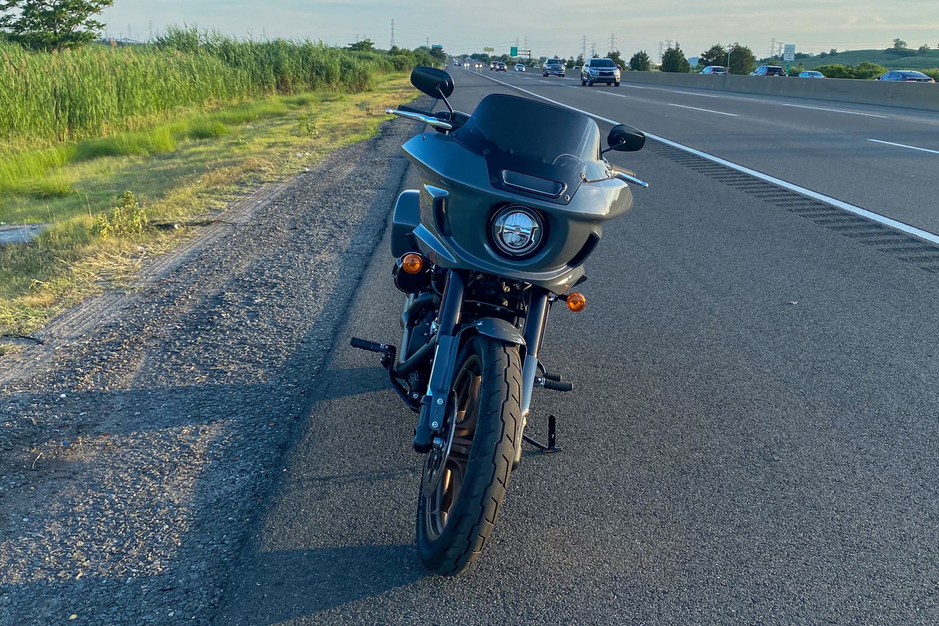 front of a harley low rider st motorcycle parked on the side of the road