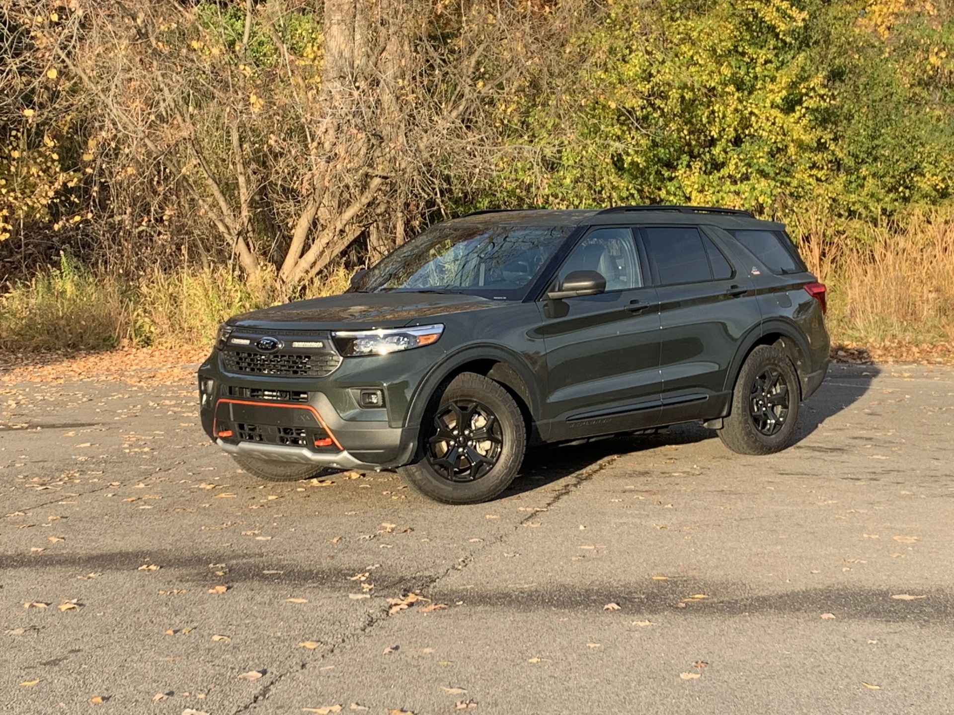 ford explorer timberline parked in front of woods