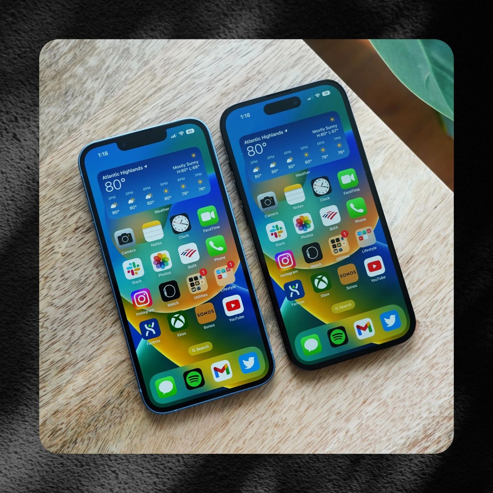 2 iphone 14 pro laying against wooden surface