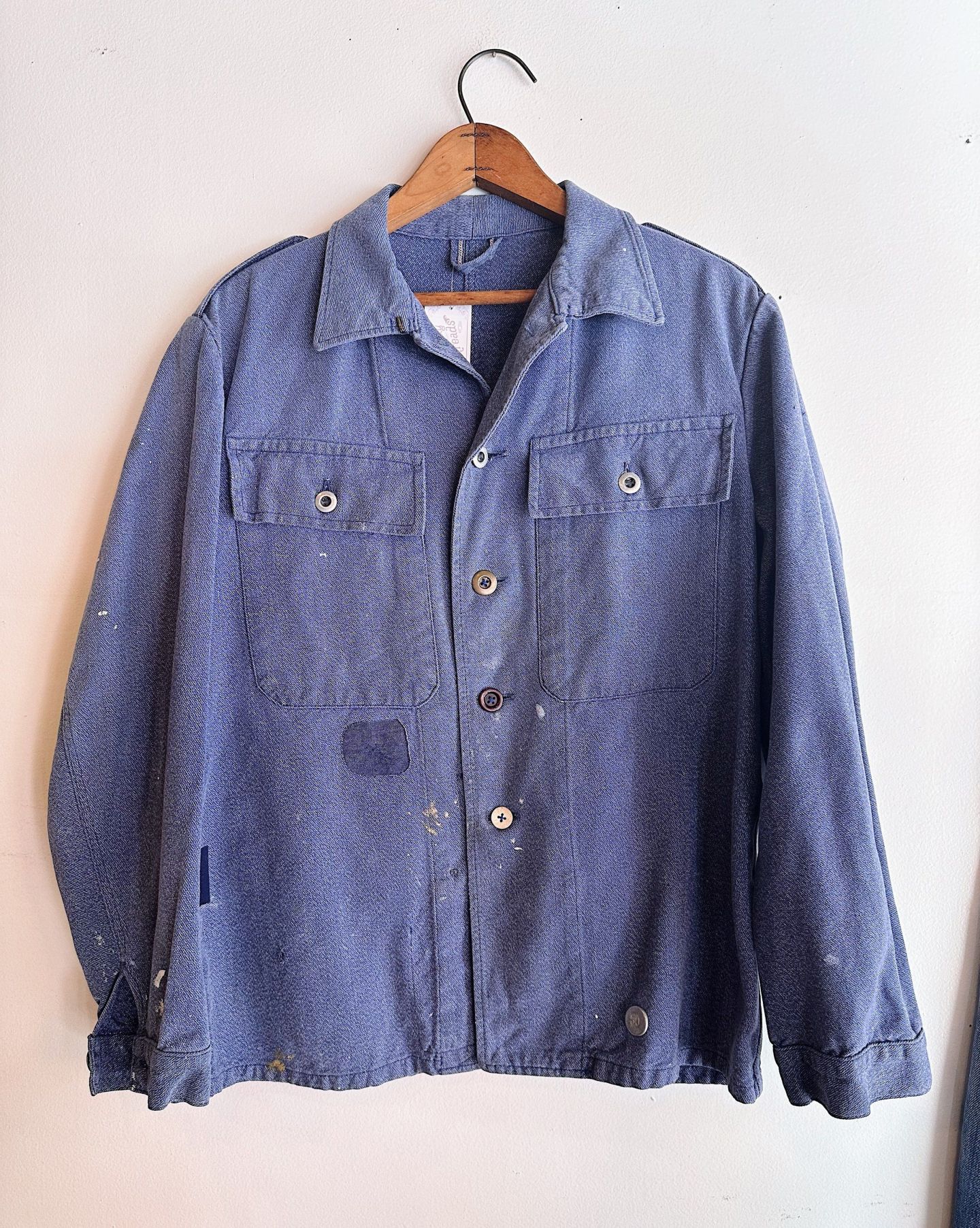 a chore coat hanging on a hanger