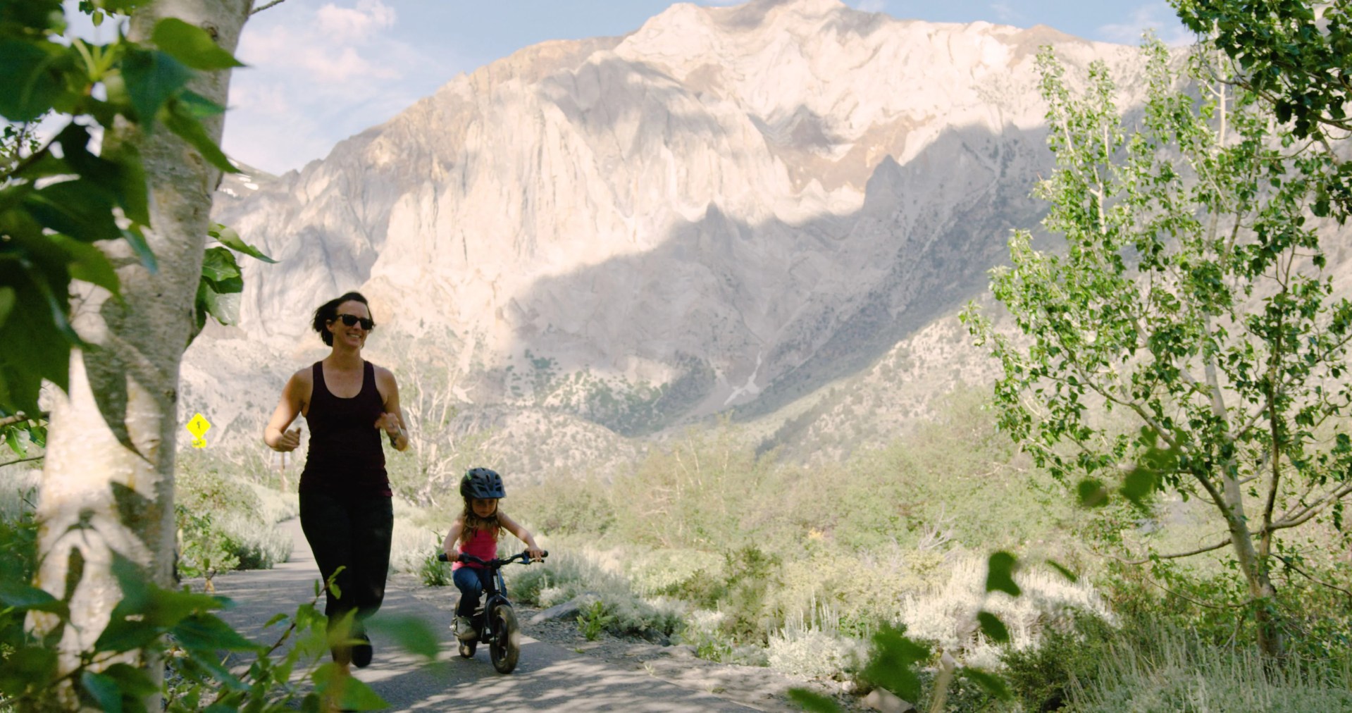 mom jogging next to daughter riding her stacyc 12edrive bmx bike