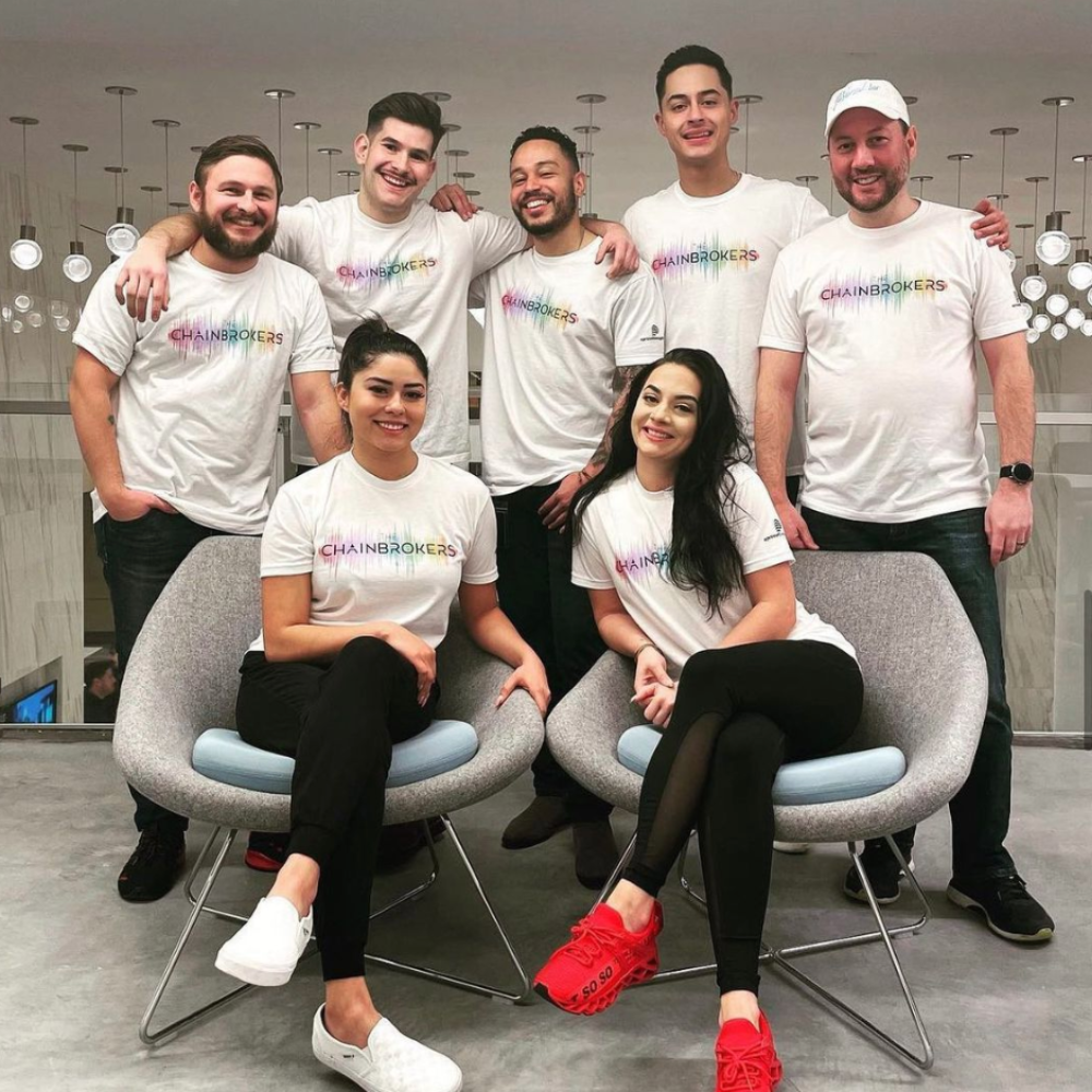 a group of people wearing a white shirt saying chain brokers printed by underground printing