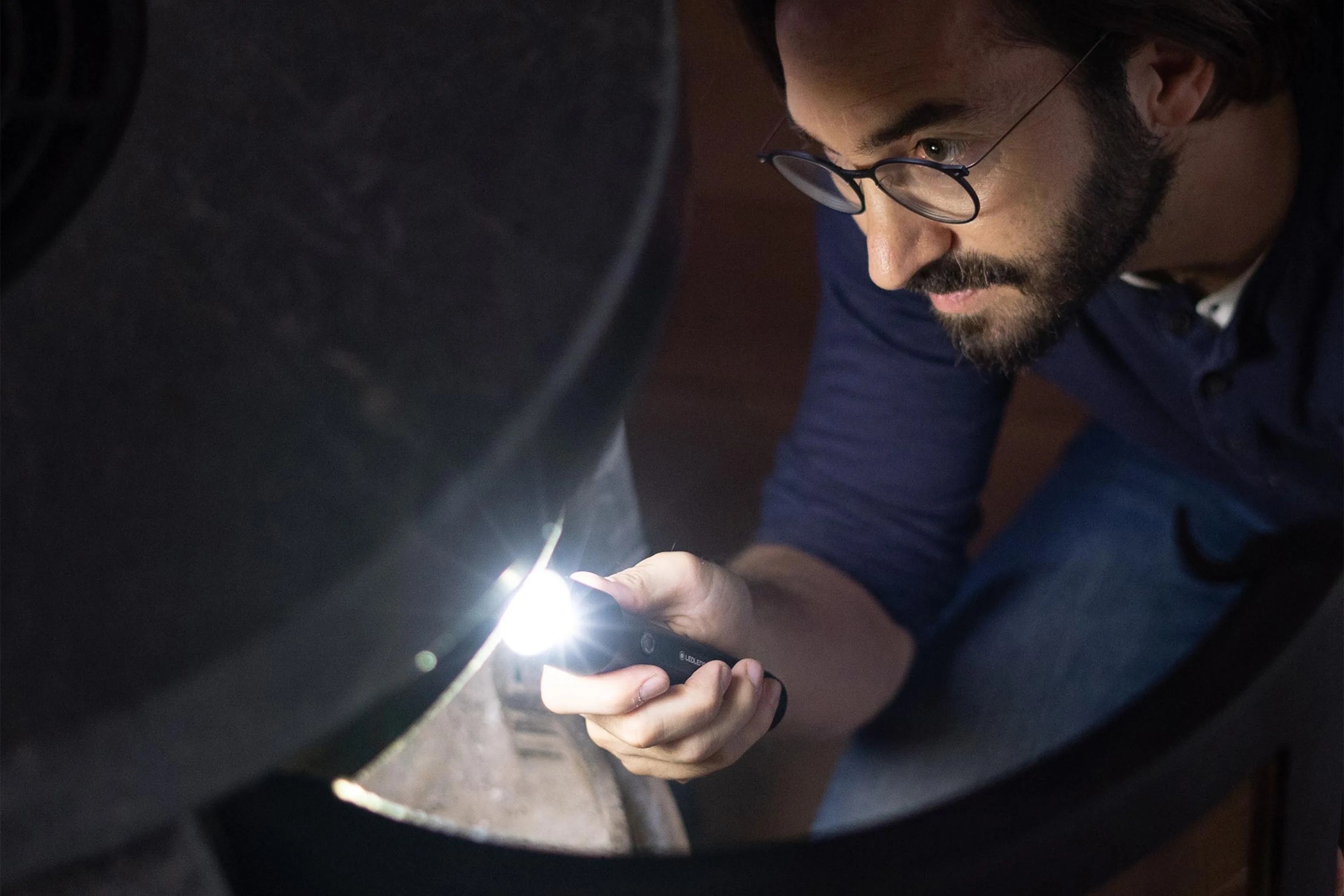 a man using a flashlight
