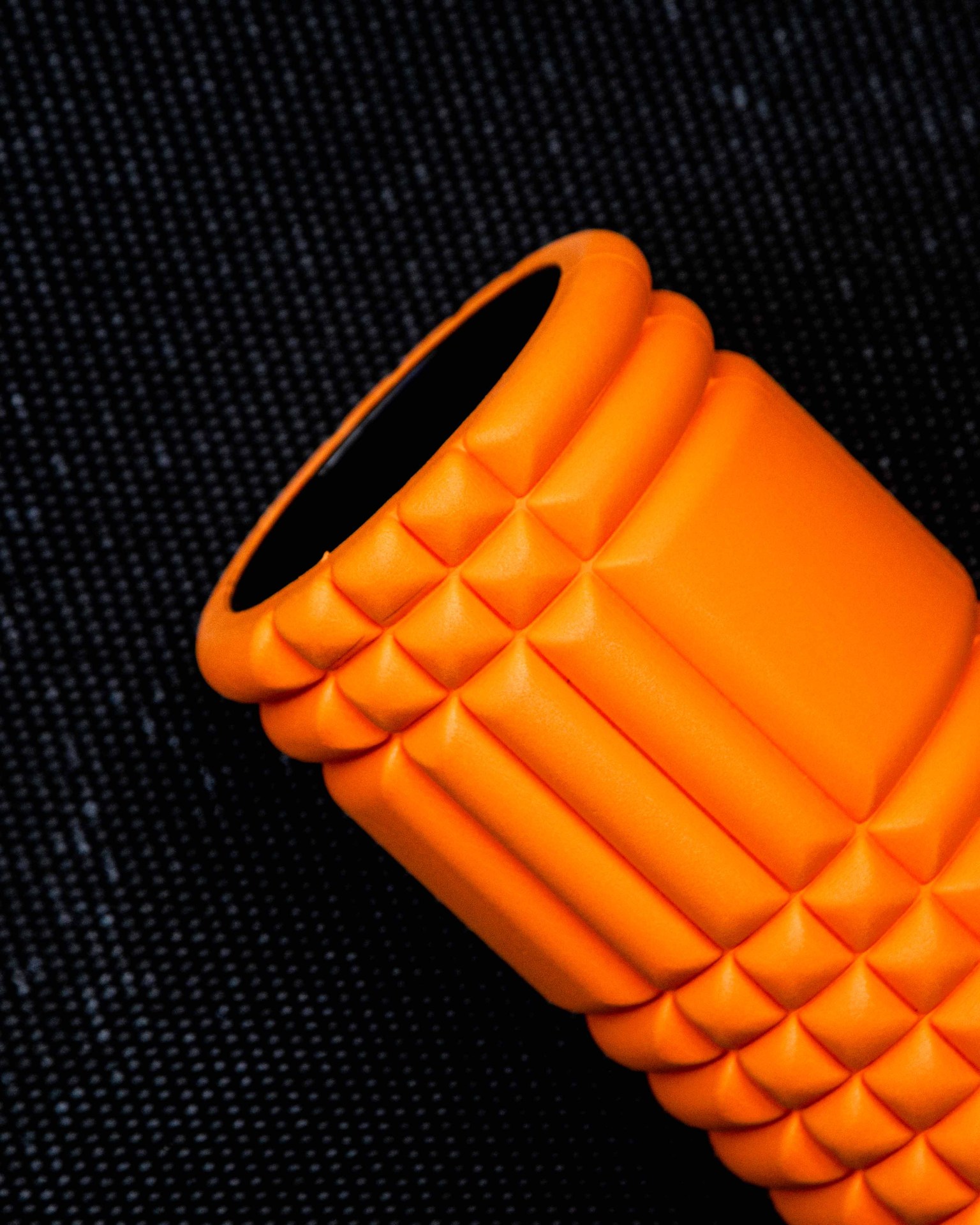 closeup photo of an orange foam roller