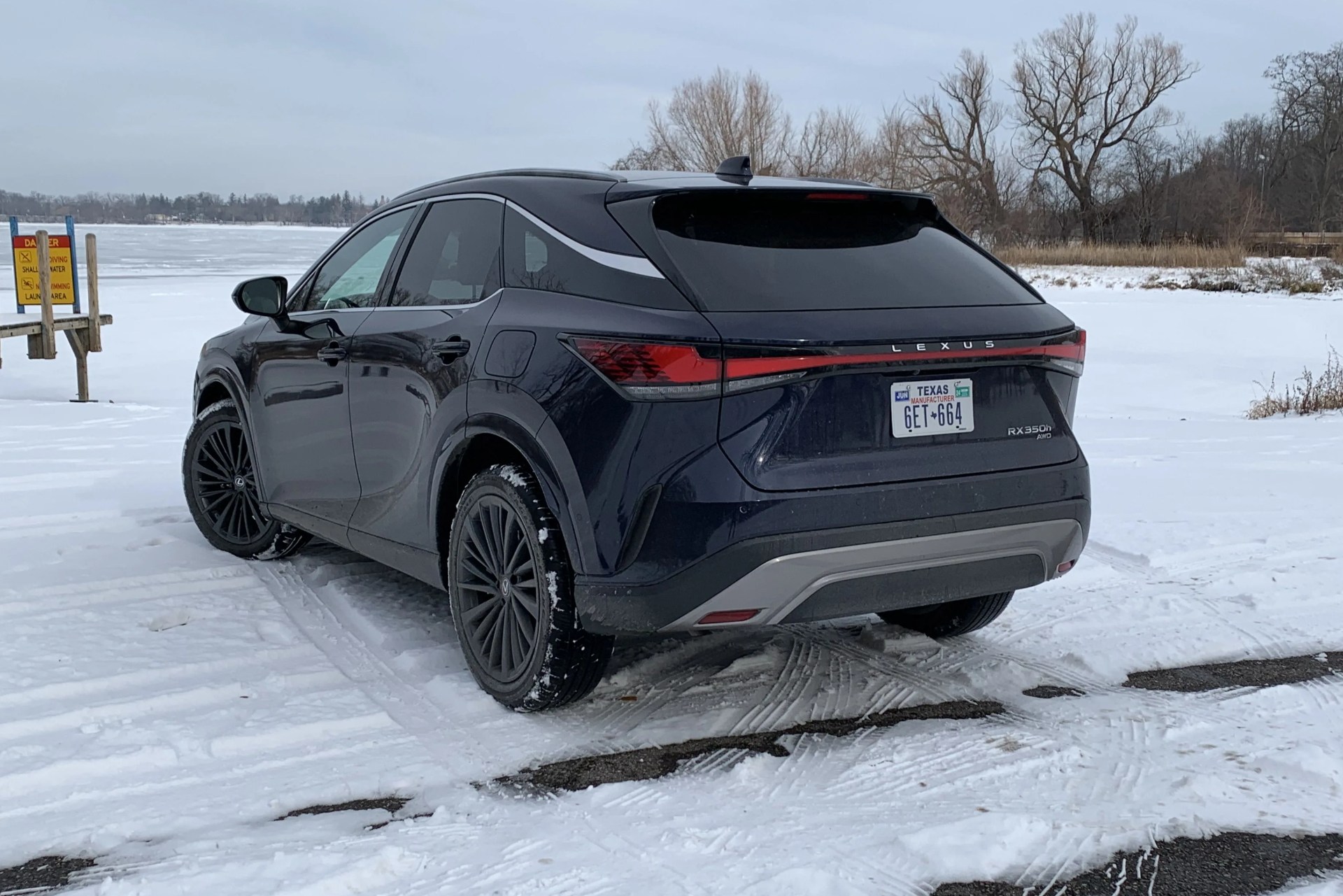 lexus rx 350h from the rear next to a snowy boat launch